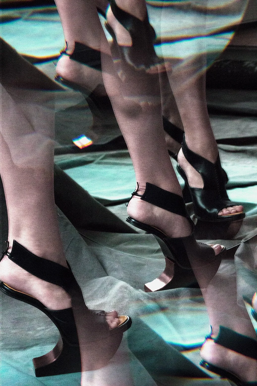 Editorial fashion image featuring black sculptural sandals fragmented by mirrored surfaces and light refractions, set design and props styling by Steffi Bühlmaier, photography by Loreen Hinz for Vision Magazine China, 2019