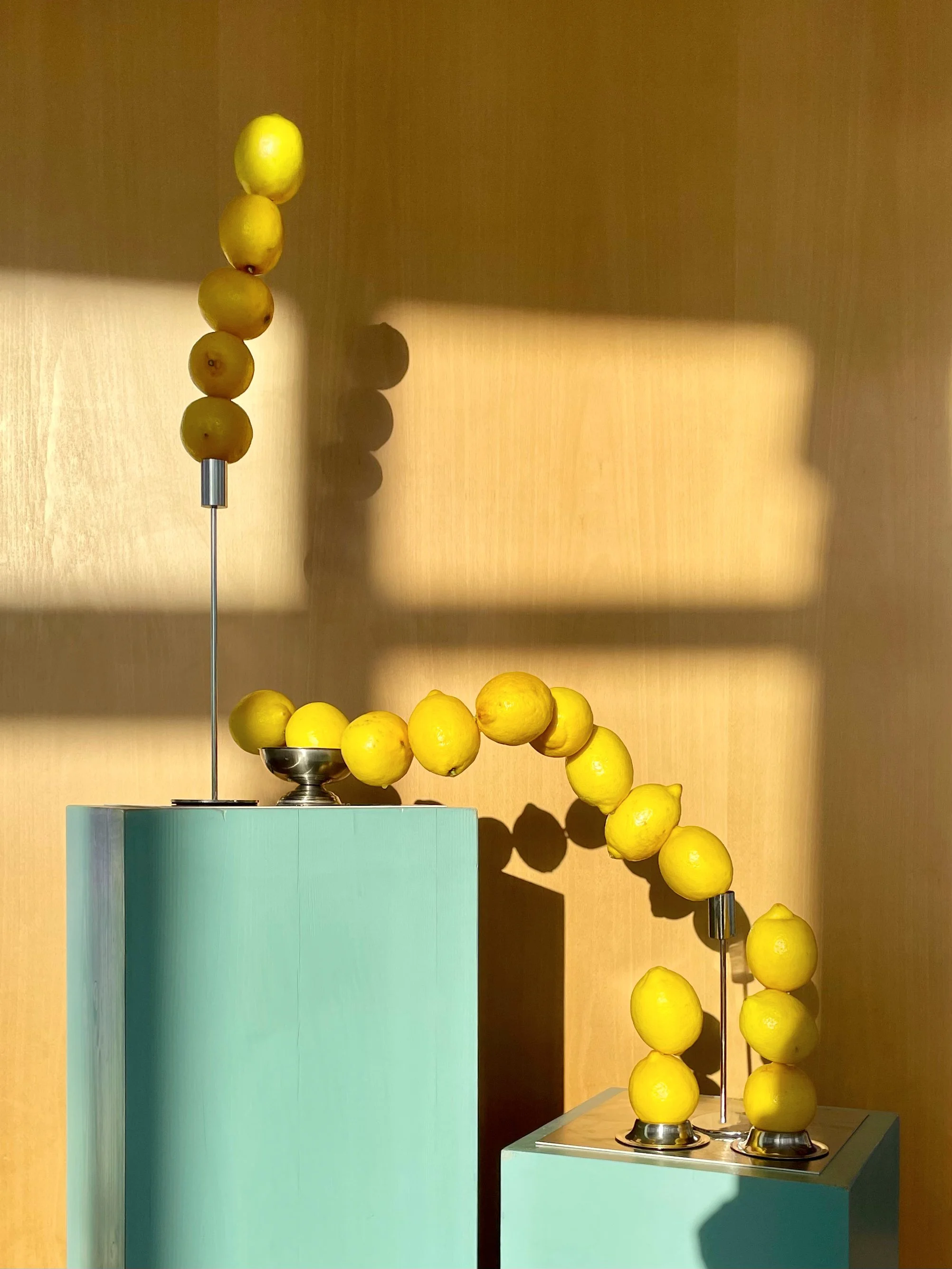 Sculptural lemon installation arranged on mint plinths in warm sunlight, event design and props styling by Steffi Bühlmaier for Lidl x Highsnobiety dinner at Ember Rooftop Berlin, production by PS:KAAS, 2025