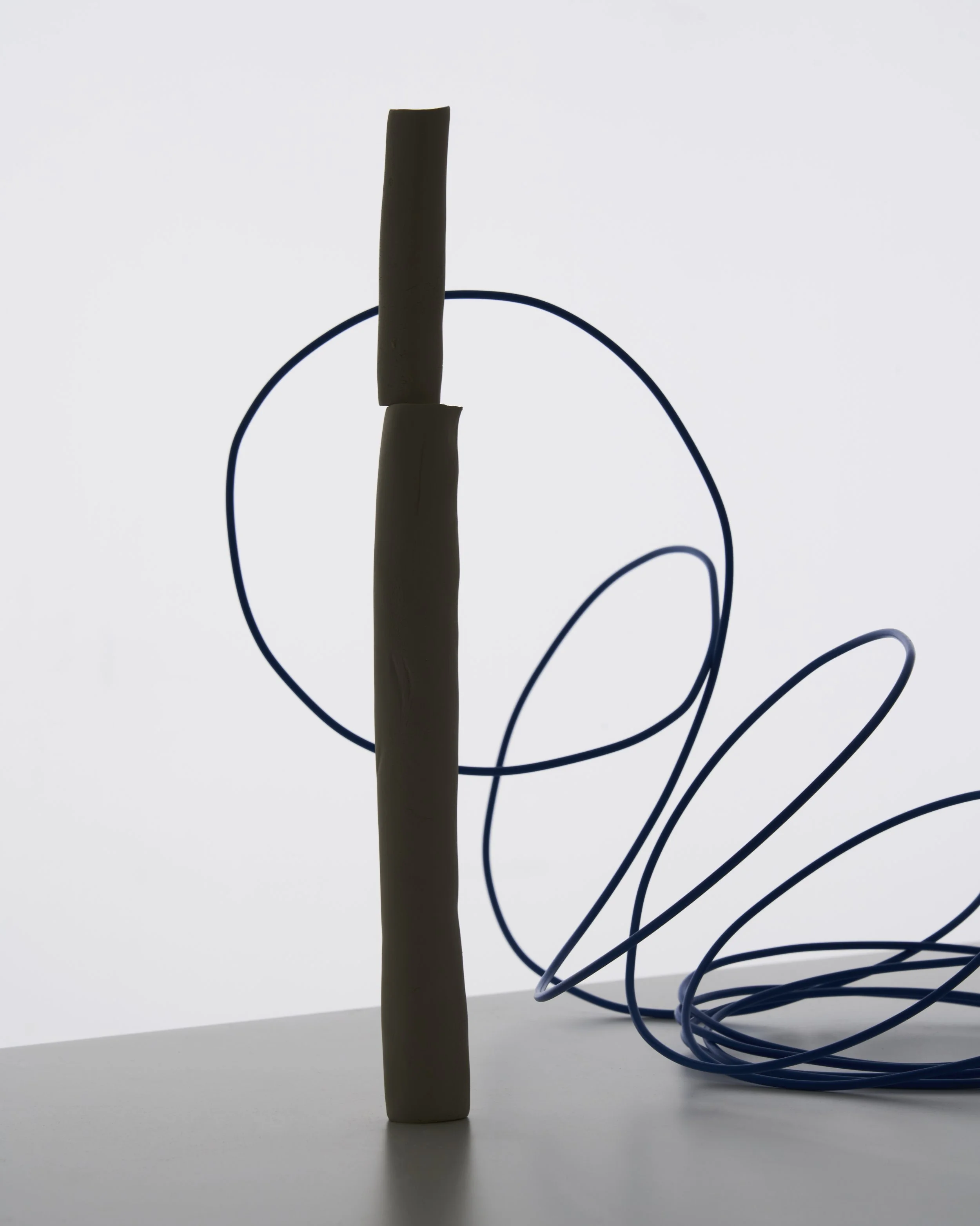 Abstract still life with sculptural clay form and blue cable, set design and props styling by Steffi Bühlmaier, photography by Paul Kusserow, 2020