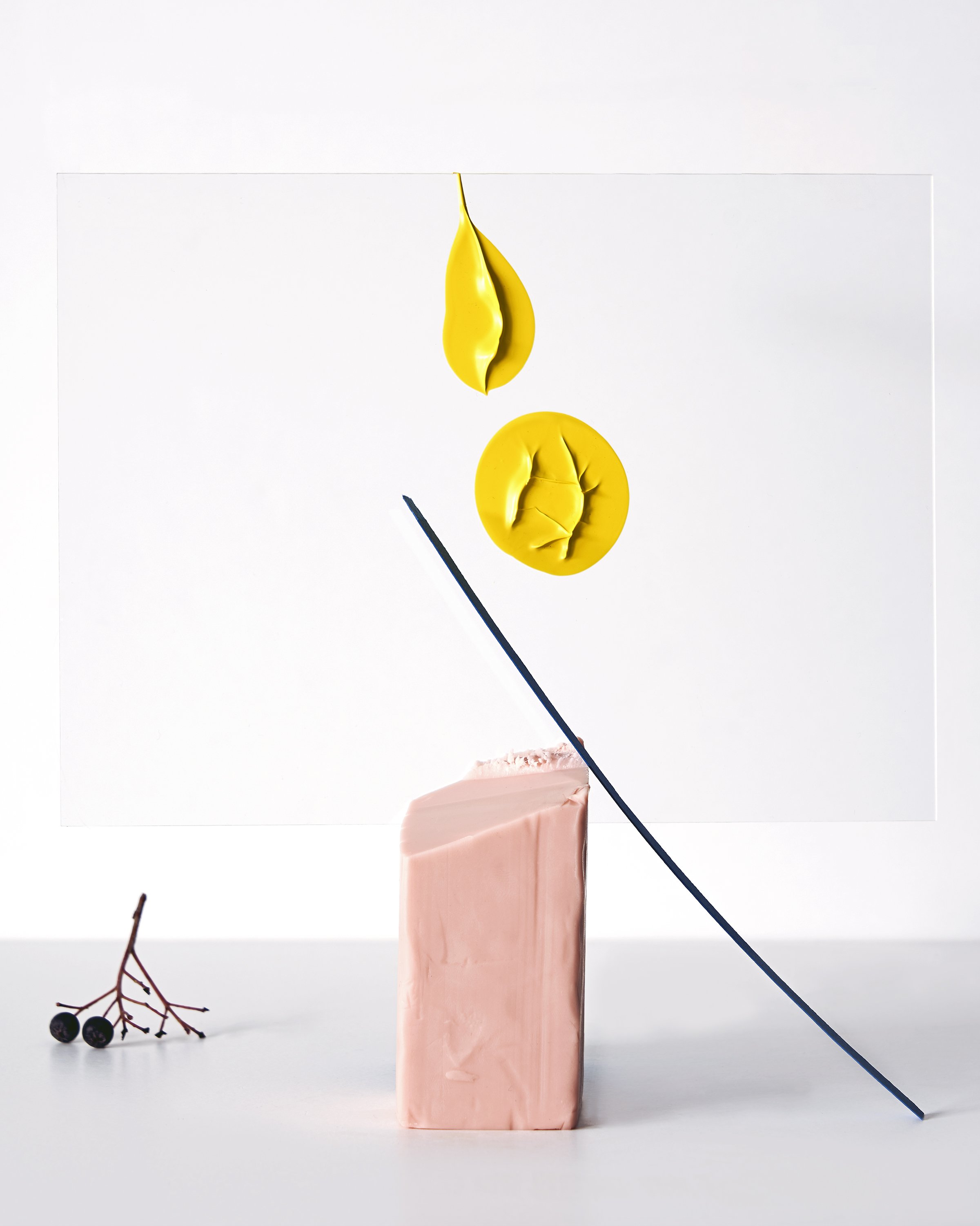 Abstract still life with yellow sculptural paint form, pink block and blue rod, set design and props styling by Steffi Bühlmaier, photography by Paul Kusserow, 2019