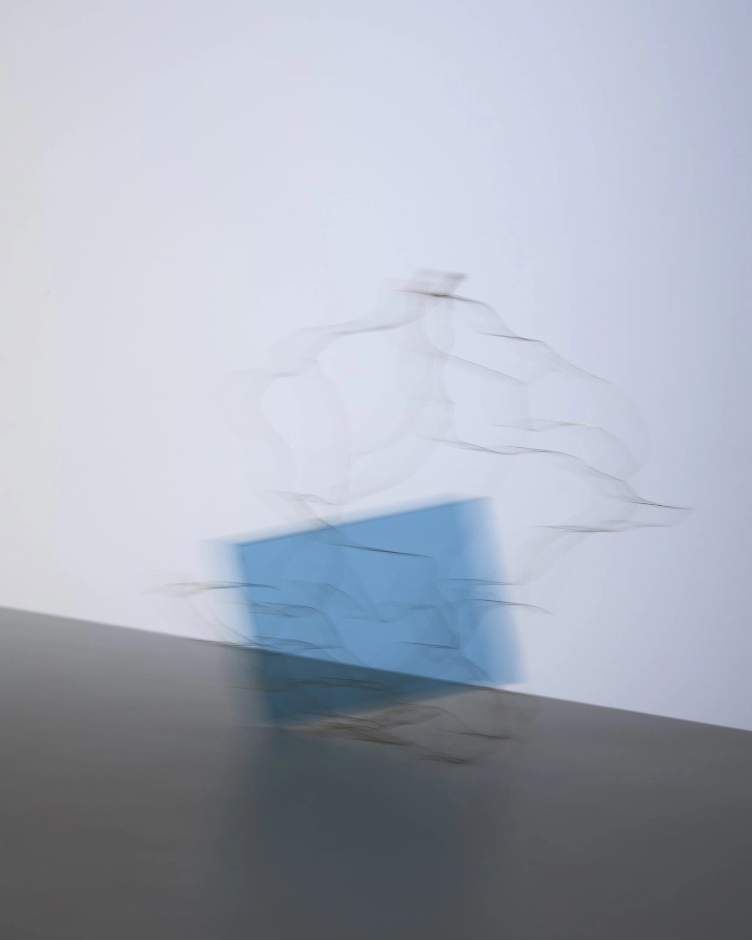 Abstract still life with motion blur and wire structure around blue acrylic panel, set design and props styling by Steffi Bühlmaier, photography by Paul Kusserow, 2020