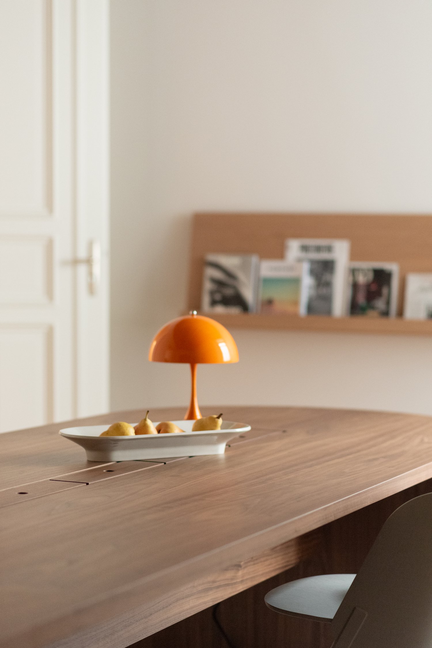 Conference table styling with orange table lamp and fruit bowl, office space in Berlin Charlottenburg, interior styling by Steffi Bühlmaier, architecture by BBPA, 2024