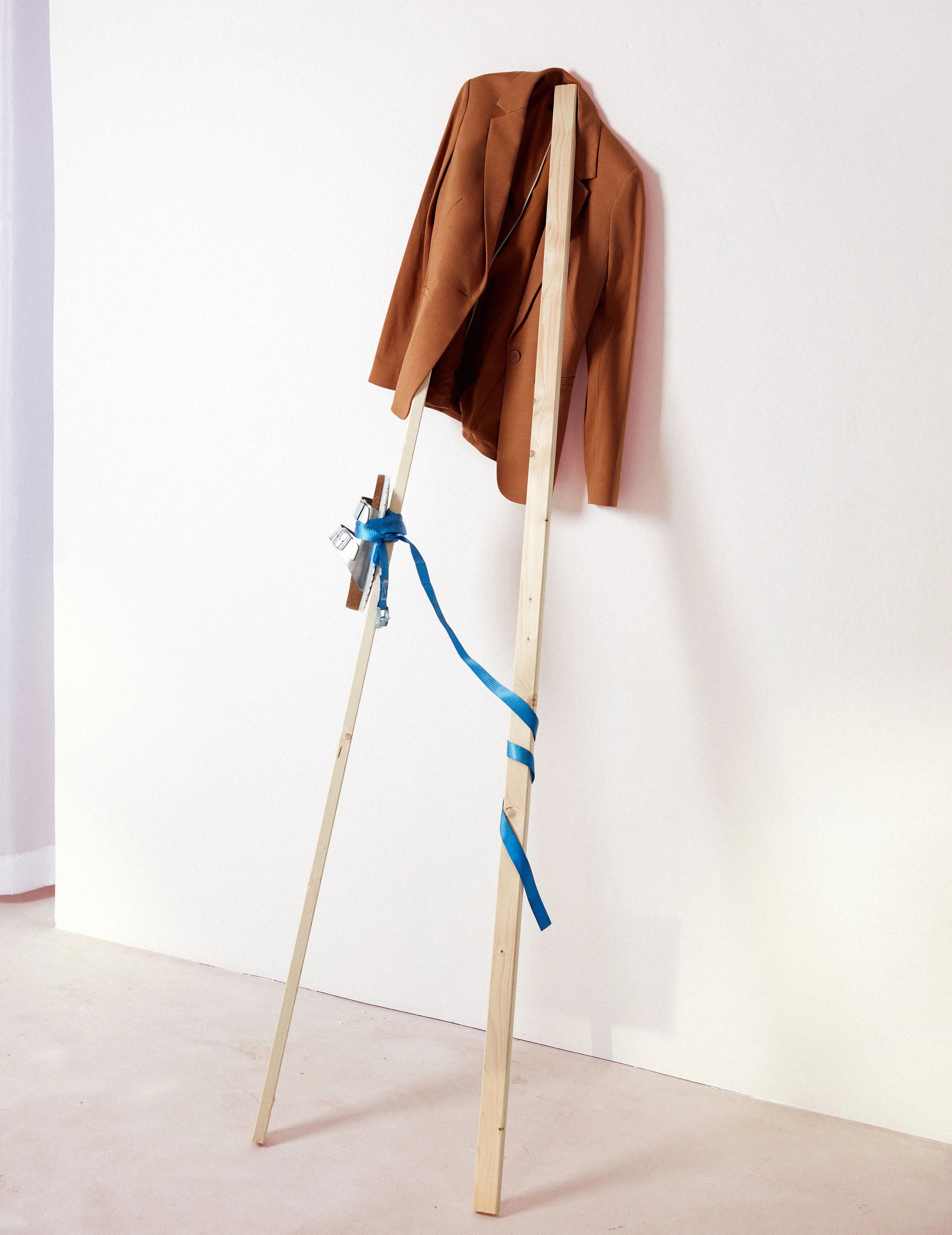 Editorial still life with brown blazer draped over wooden beams with blue strap detail, art direction by Steffi Bühlmaier, photography by Jessica Grossmann for Heyday Magazine, 2022