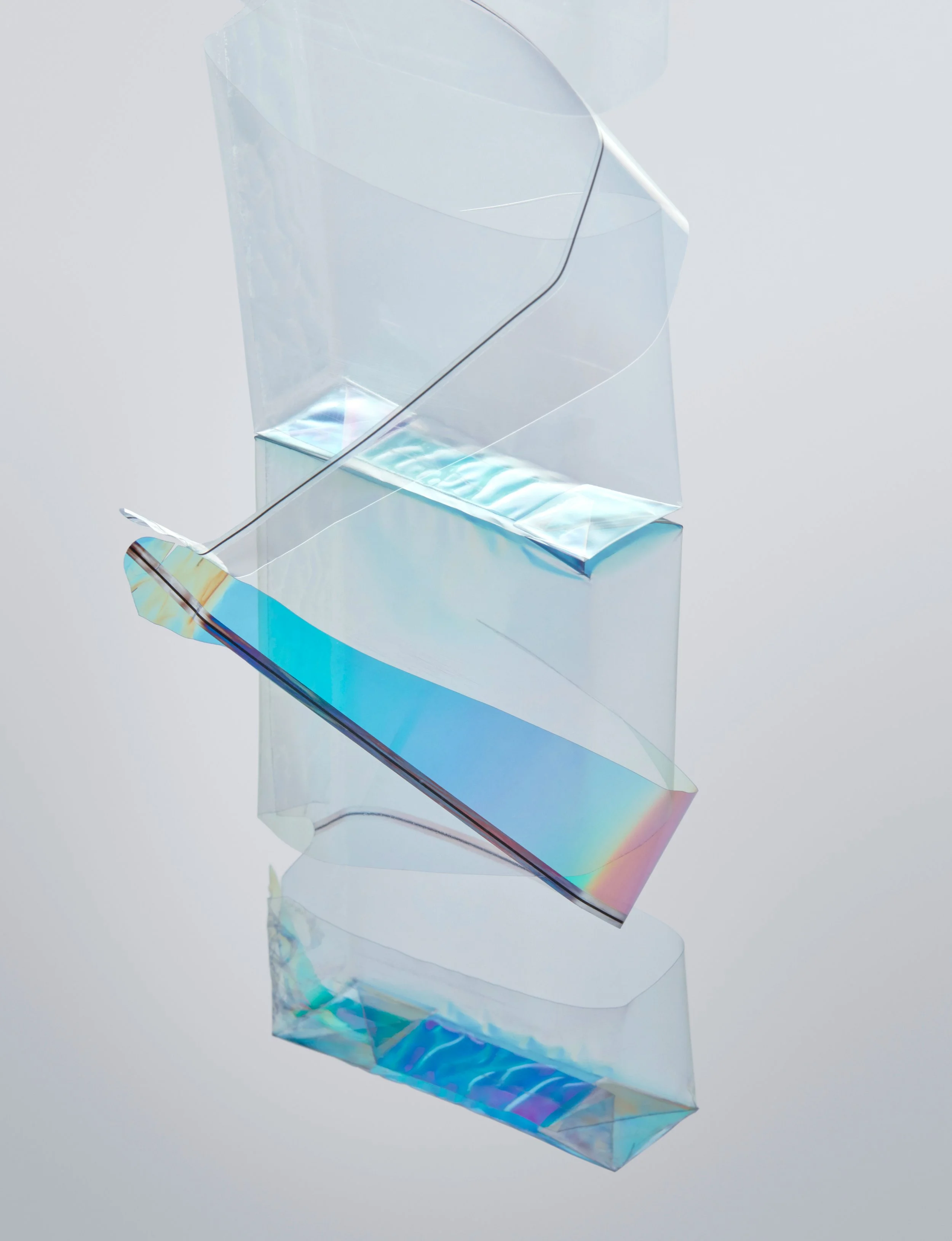 Abstract still life with translucent packaging foil refracting light into spectral colors, props styling by Steffi Bühlmaier, photography by Tobias Bärmann, postproduction by Studio Wolfram, published in Slanted 38, 2018