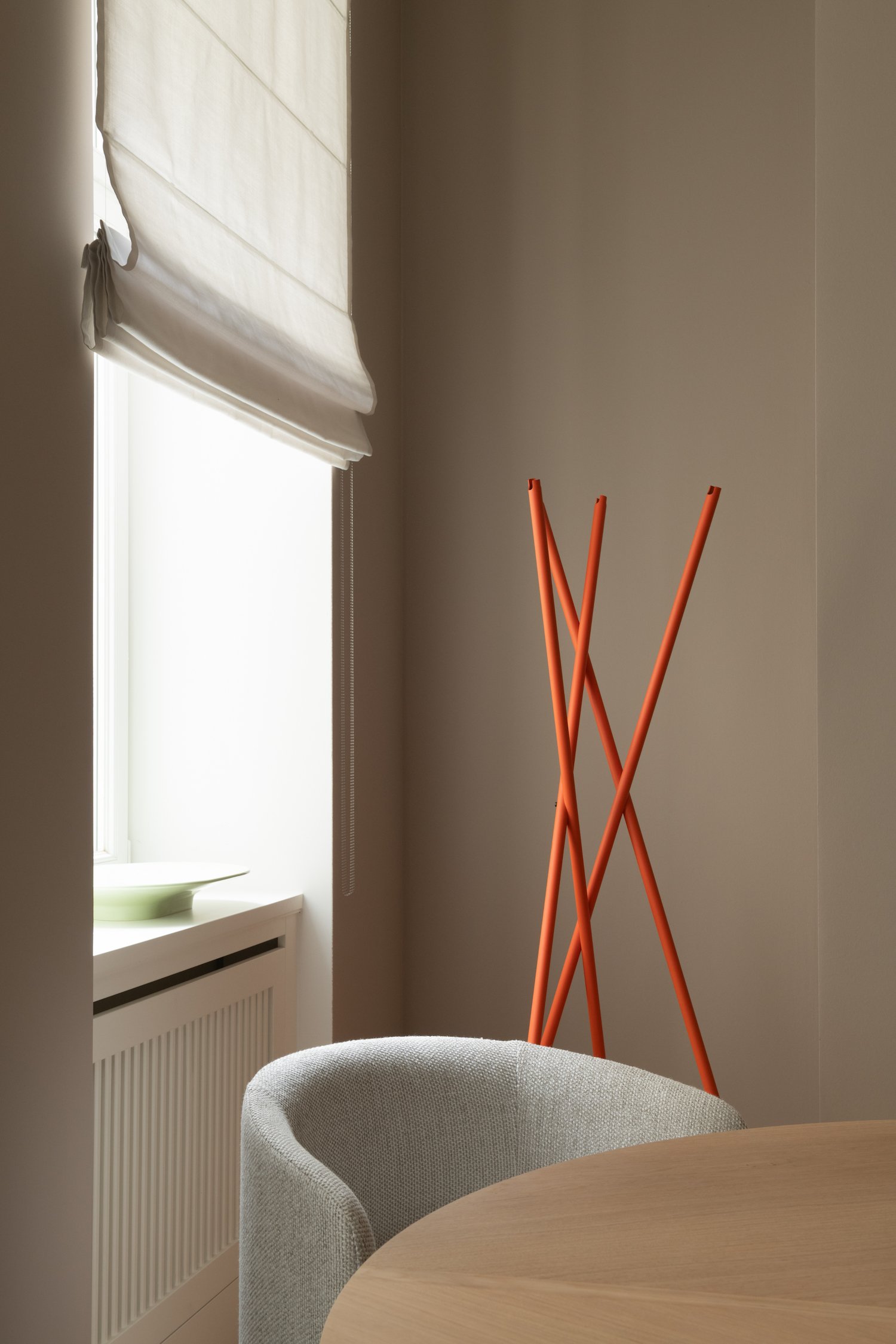 Office corner with orange coat rack and soft daylight, workspace in Berlin Charlottenburg, interior styling by Steffi Bühlmaier, architecture by BBPA, 2024