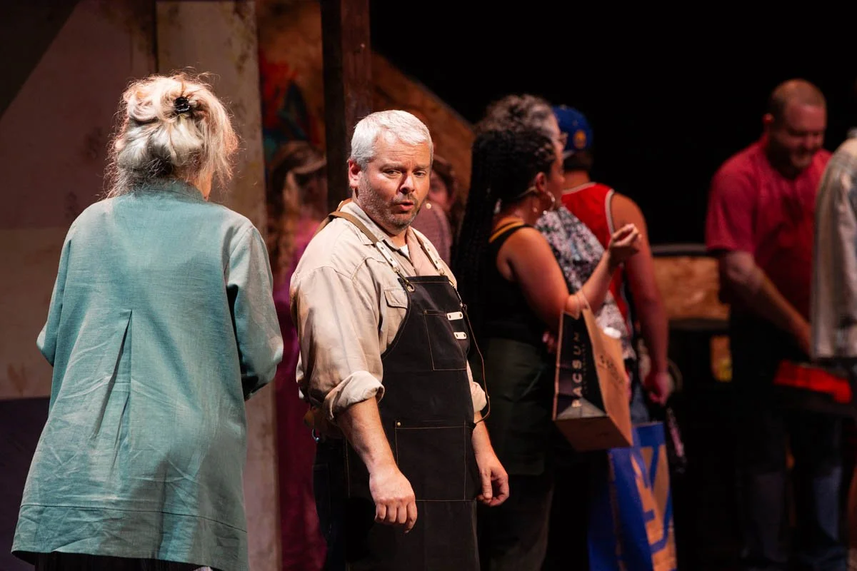 People standing in line backstage at a theatrical performance.
