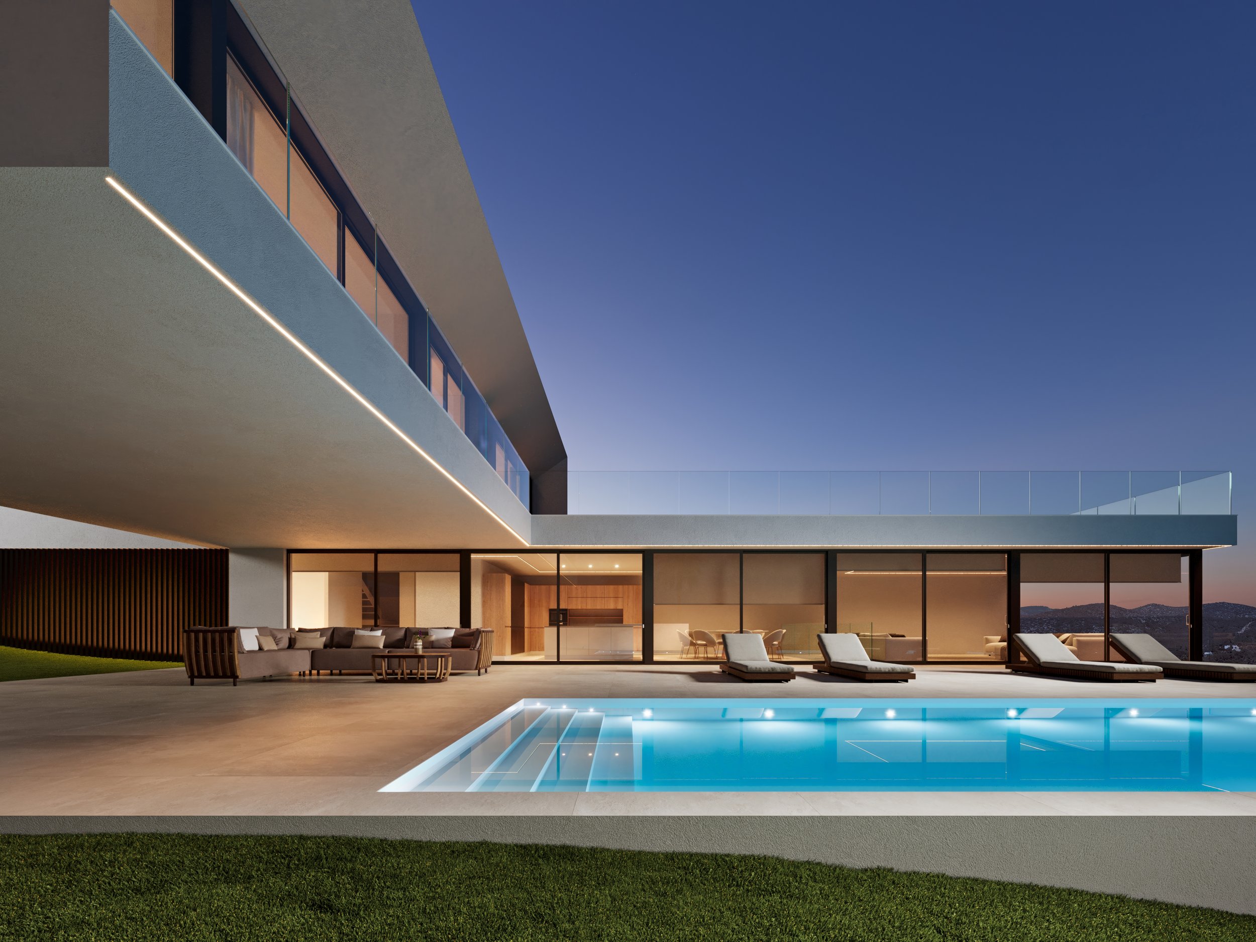 Modern house with glass windows and a swimming pool outside during evening.