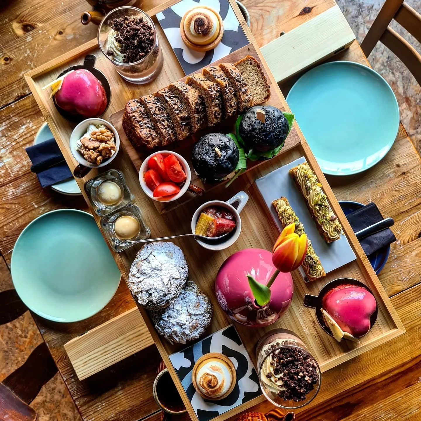 Assorted pastries, cakes, and desserts on a wooden table at Mara Restaurant Waterford