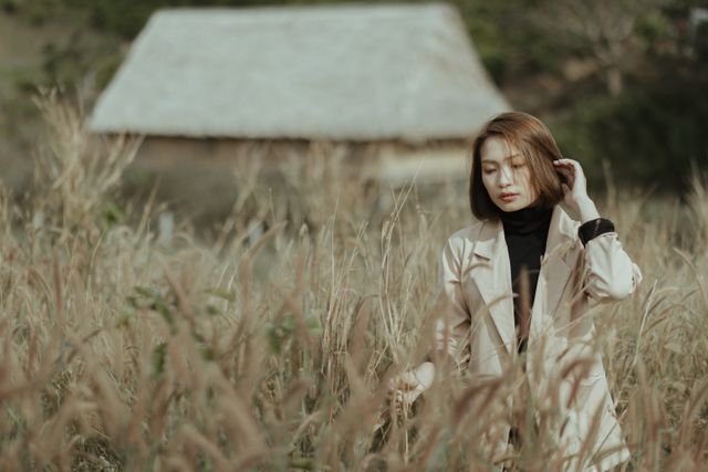 woman in field of tall grass