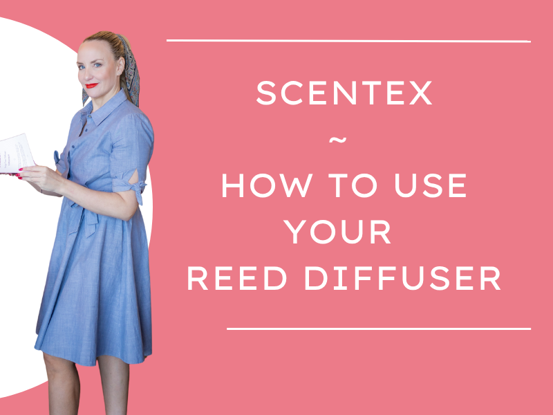 A woman (Tiffany Rose Goodyear) in a blue dress holding a notebook or manual, standing next to a pink background with white text that says: 'Scentex ~ How to use your reed diffuser'.