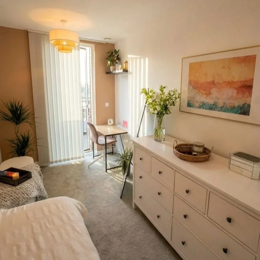 Bright bedroom with white chest of drawers and layered neutral styling, Battersea London flat by Rodolfo Falcao