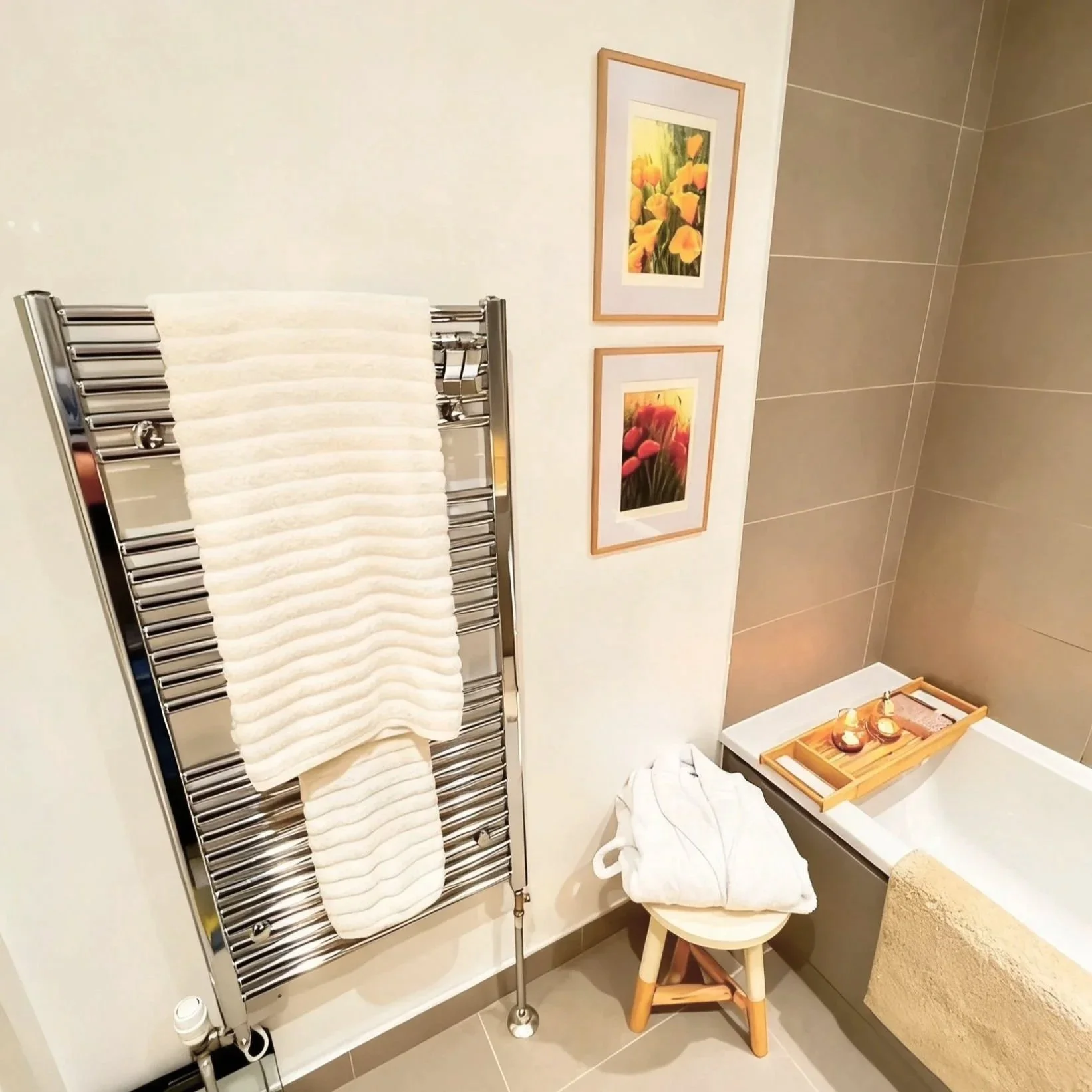 Spa-inspired bathroom with heated towel rail and framed artwork, Battersea London flat by Rodolfo Falcao
