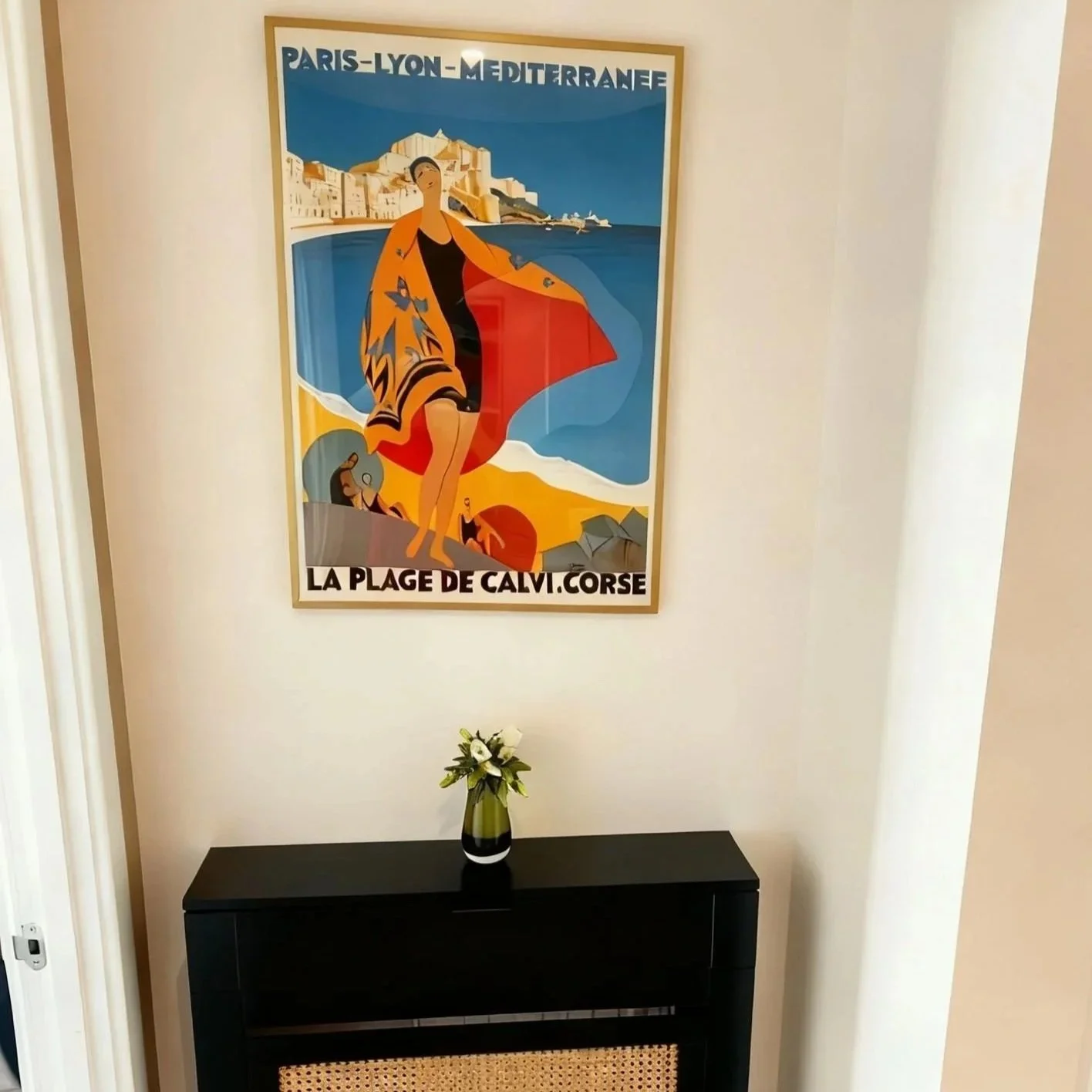 Vintage French Riviera travel poster above black console table, Battersea London flat by Rodolfo Falcao