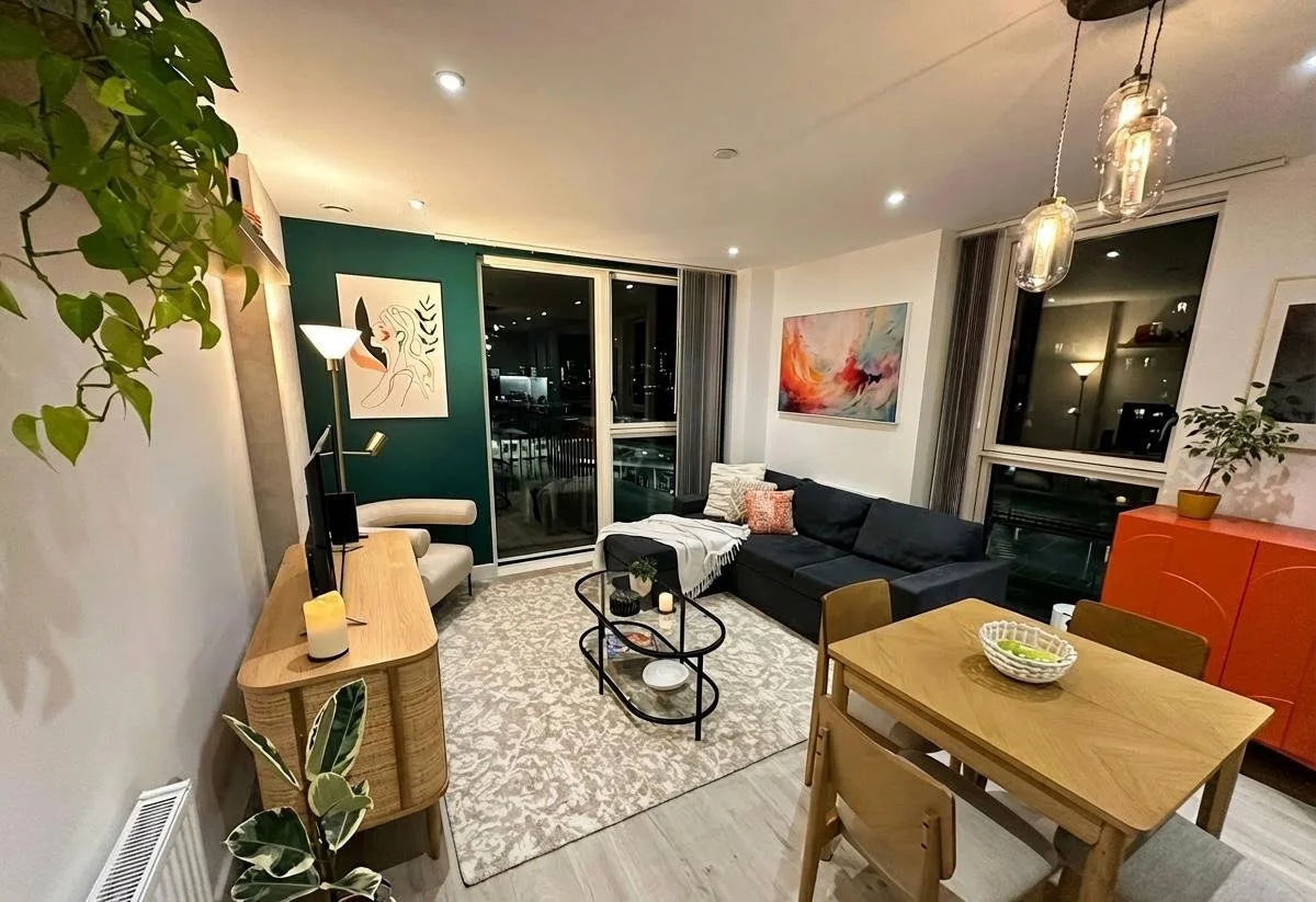 Living room with forest green accent wall, patterned rug and city views, Battersea London by Rodolfo Falcao