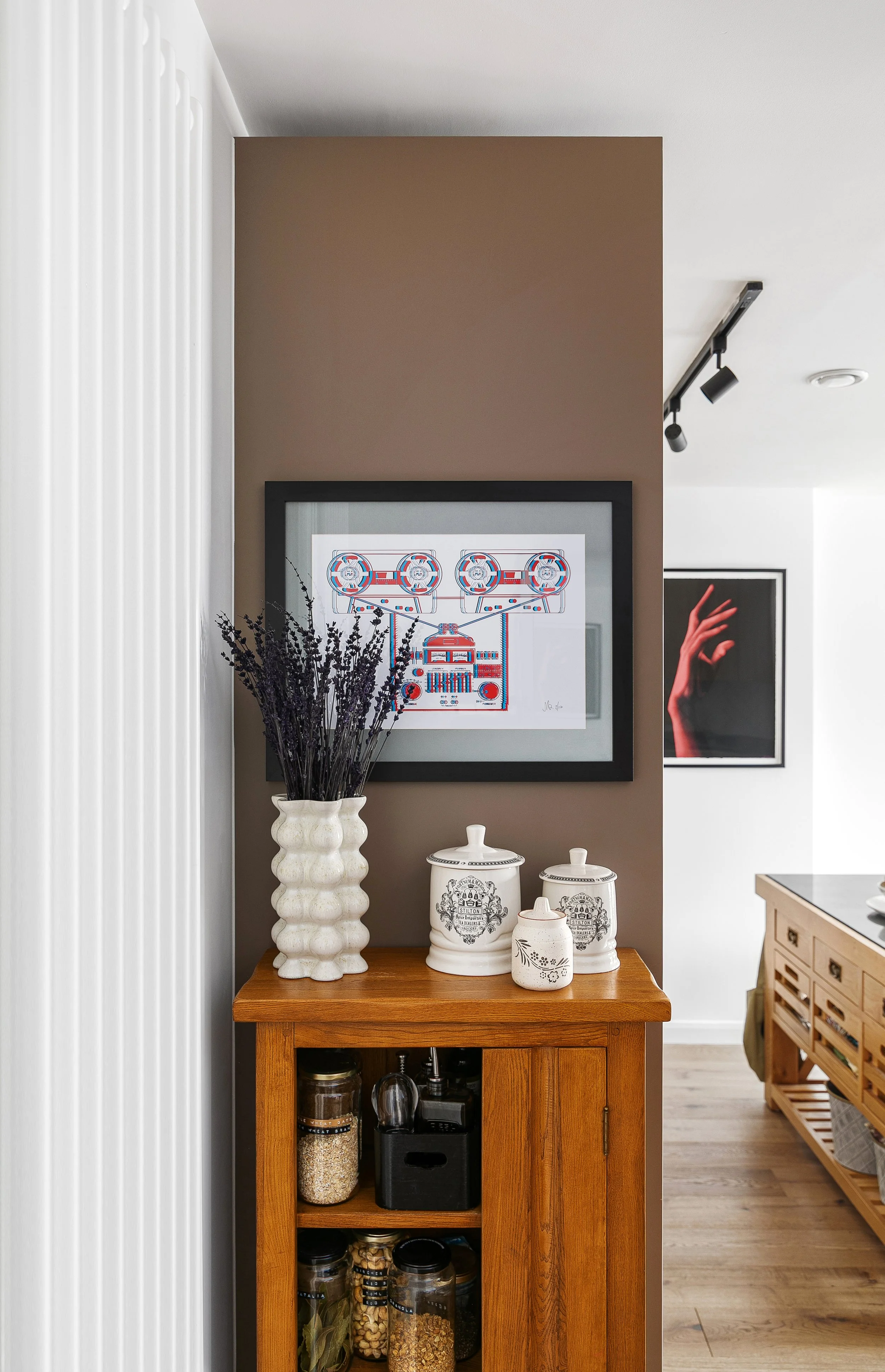 Styled console table with ceramic vessels and framed artwork, Bow East London apartment interior design by Rodolfo Falcao