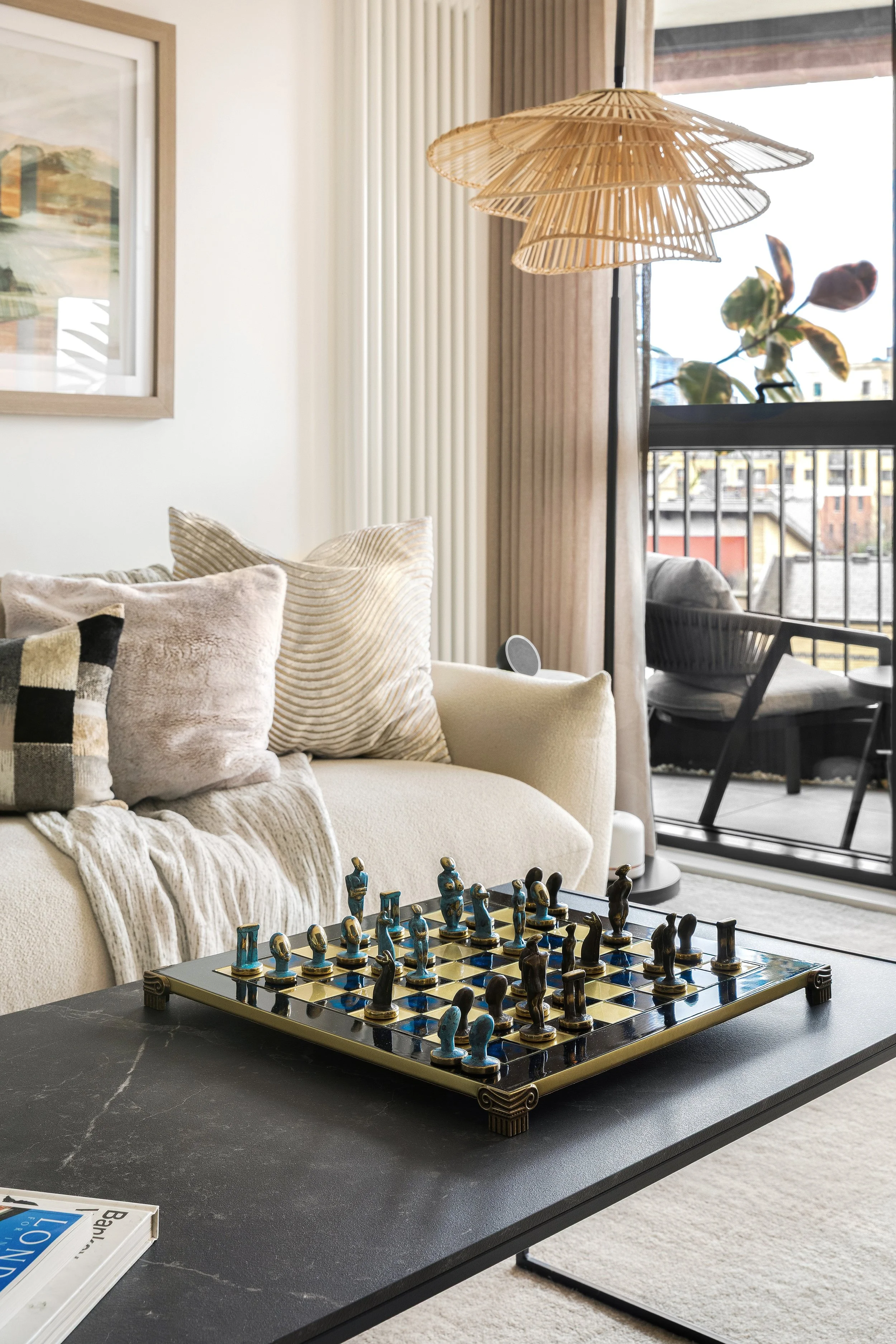 Living room with Cycladic chess set and layered textile styling, Limehouse Cut London apartment by Rodolfo Falcao