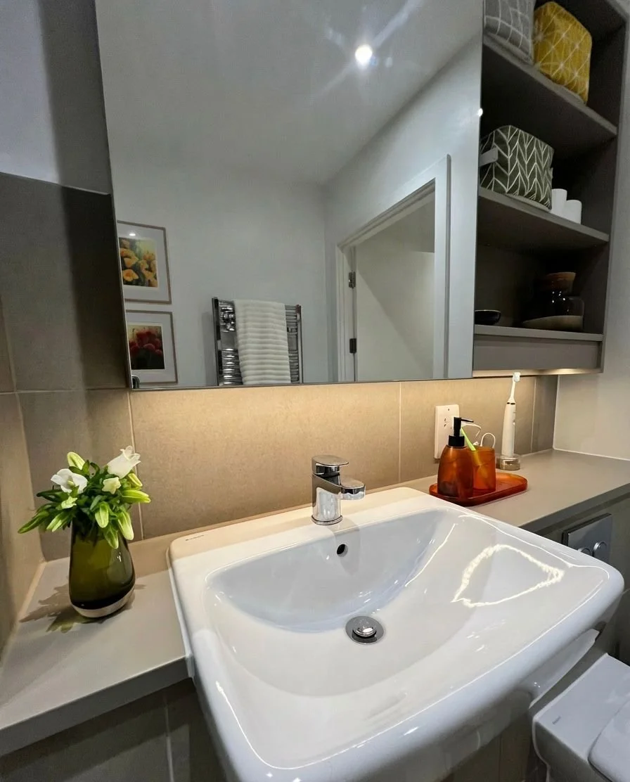 Styled bathroom vanity with sink, mirror and fresh flowers, Battersea London interior design by Rodolfo Falcao