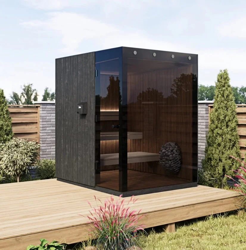 A modern outdoor sauna with dark wood and glass walls. Order yours and get luxury spa feeling within 2 weeks