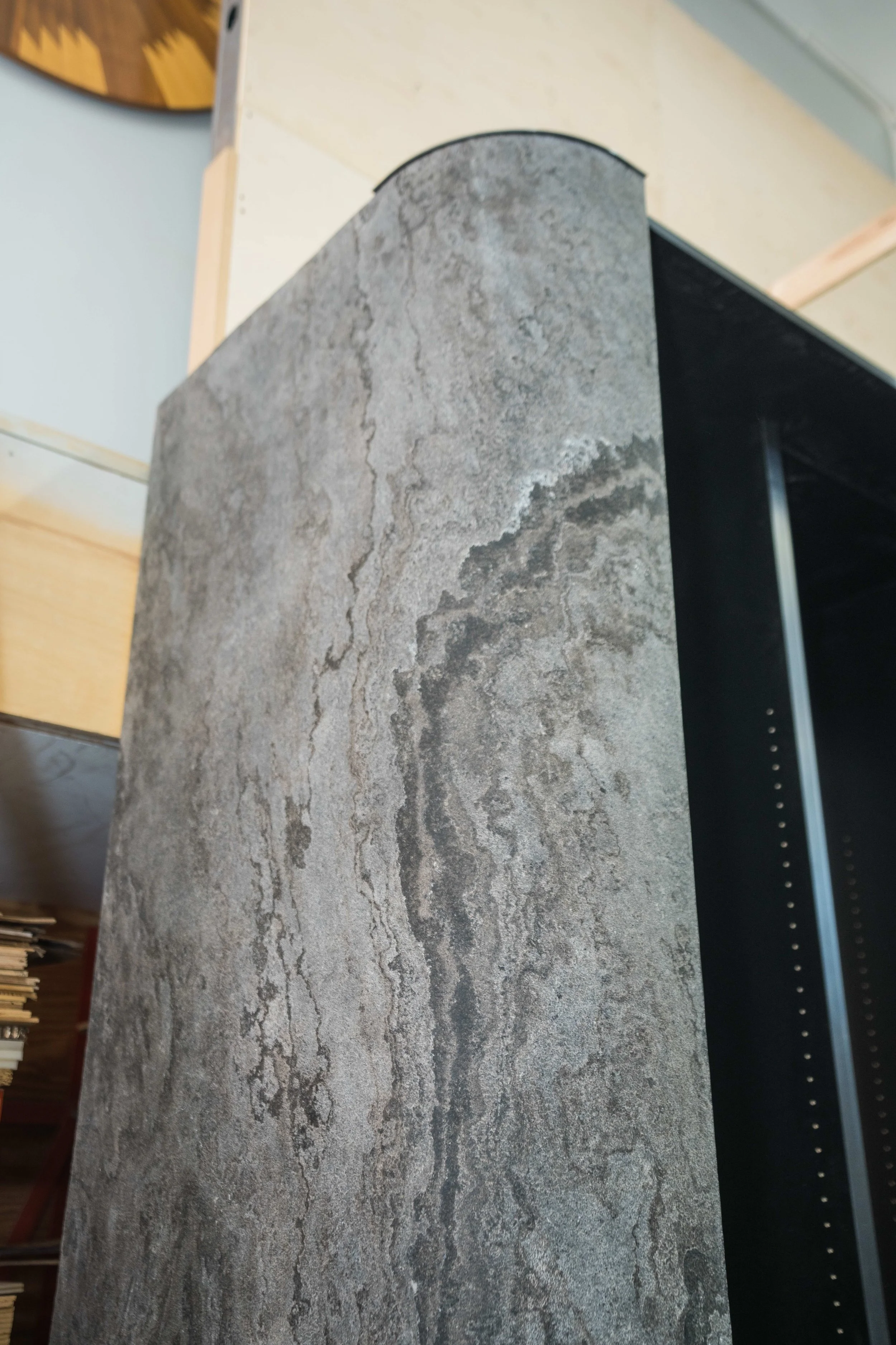 Close-up photo of a piece of gray stone or marble with natural veining and texture.