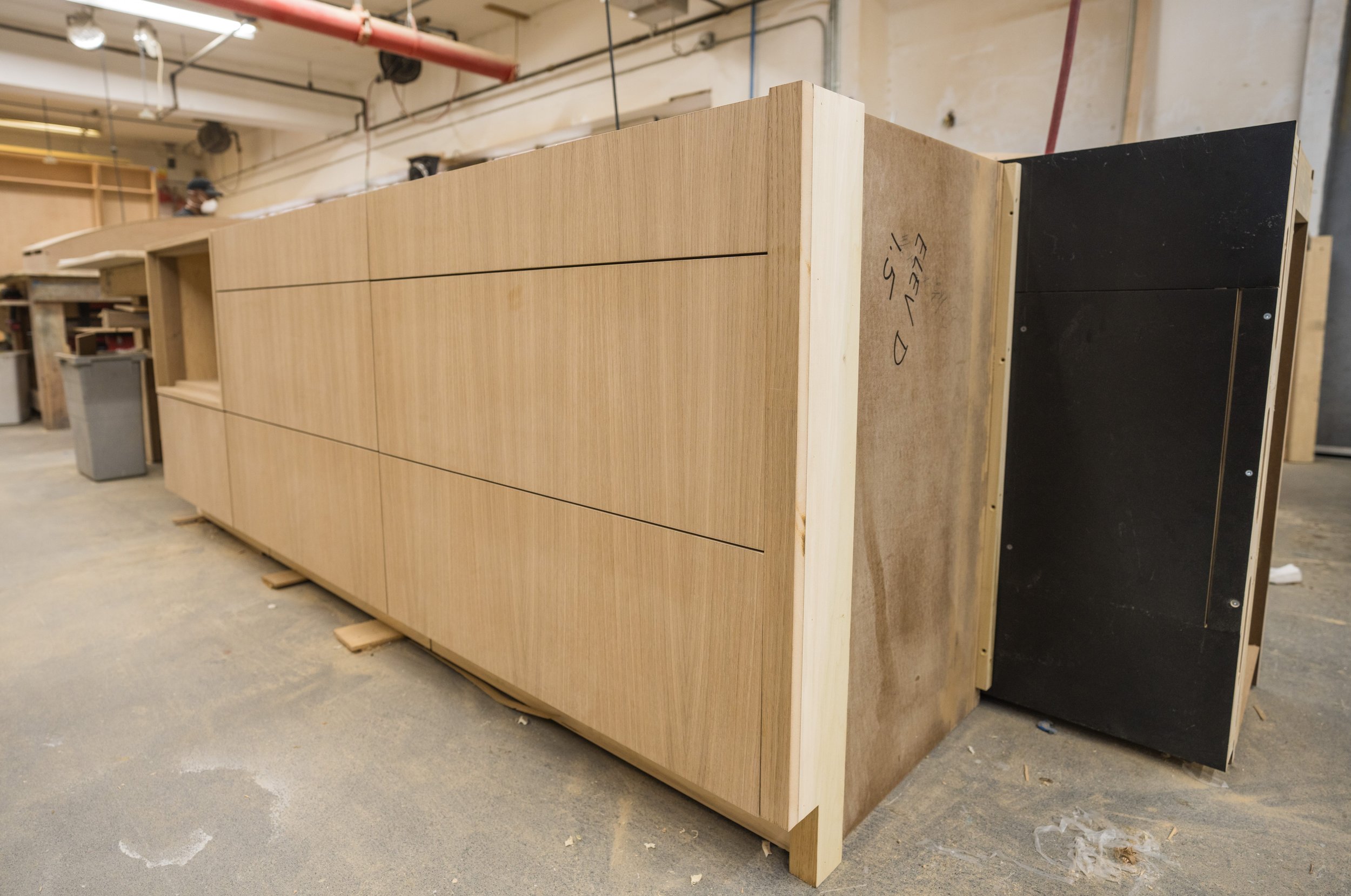 Wooden furniture piece under construction in a woodworking shop.