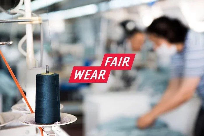 Fair Wear logo over garment factory image