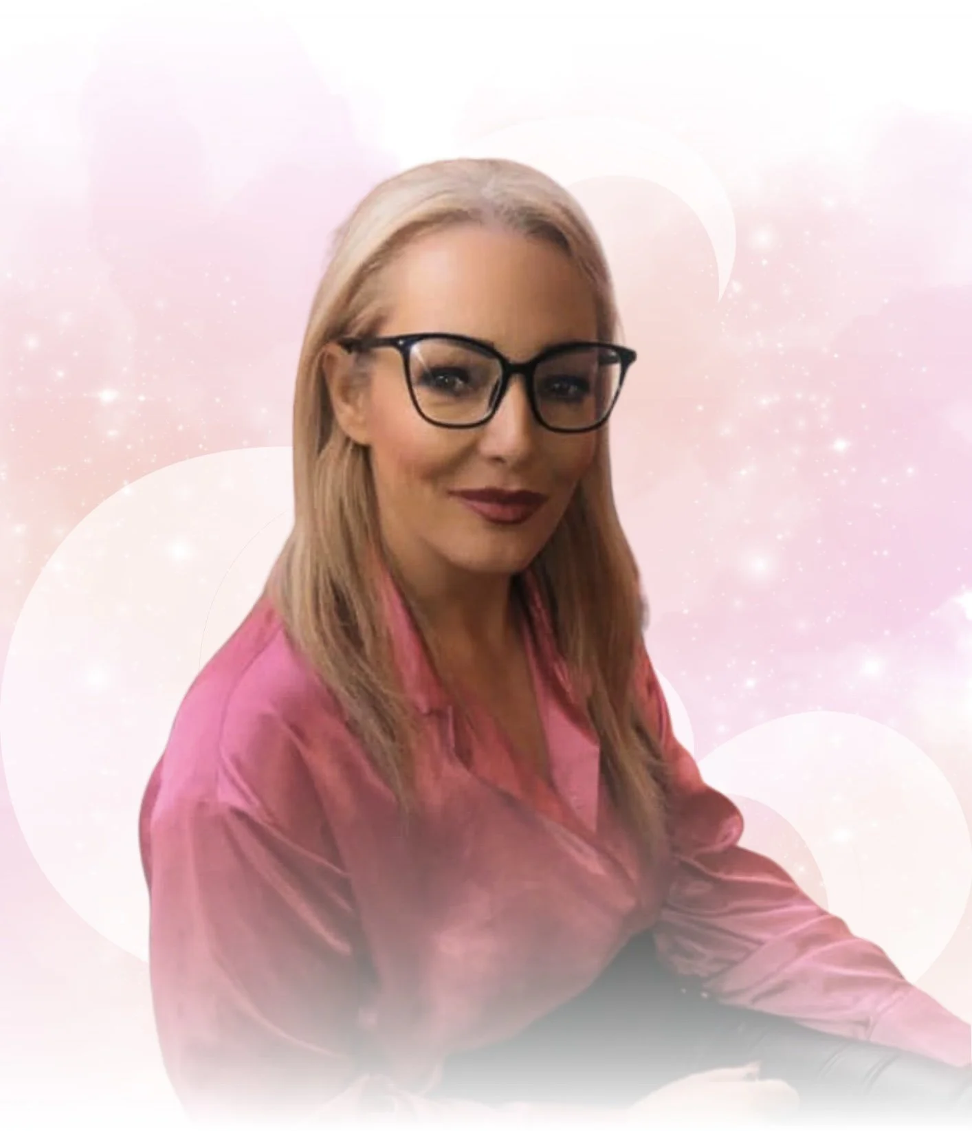 A woman with blonde hair, black glasses, and a pink satin shirt smiling against a pink, starry background with light circles and a crescent moon.