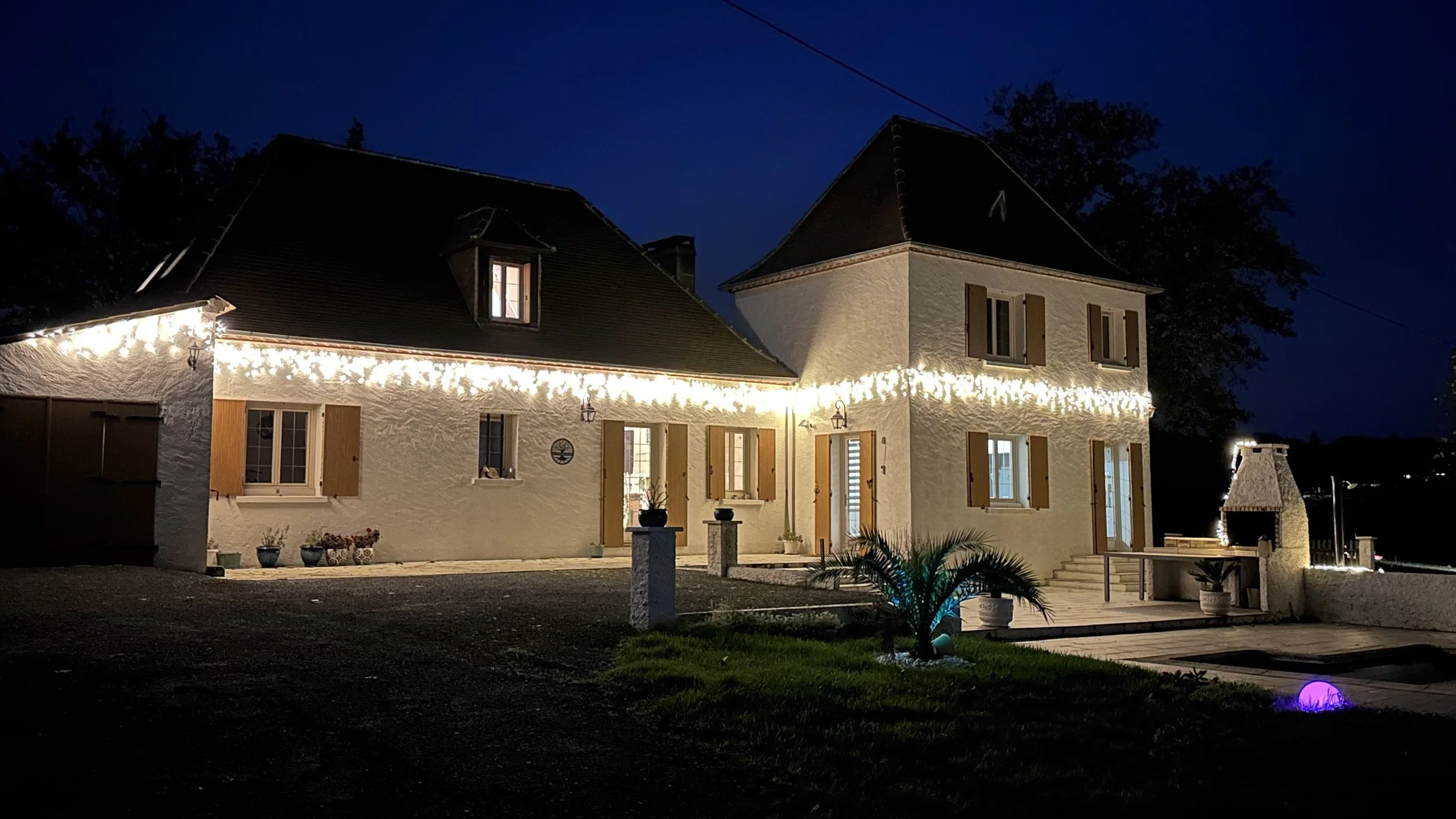 French House La Tour Blanche at night decorated with lights for Christmas.