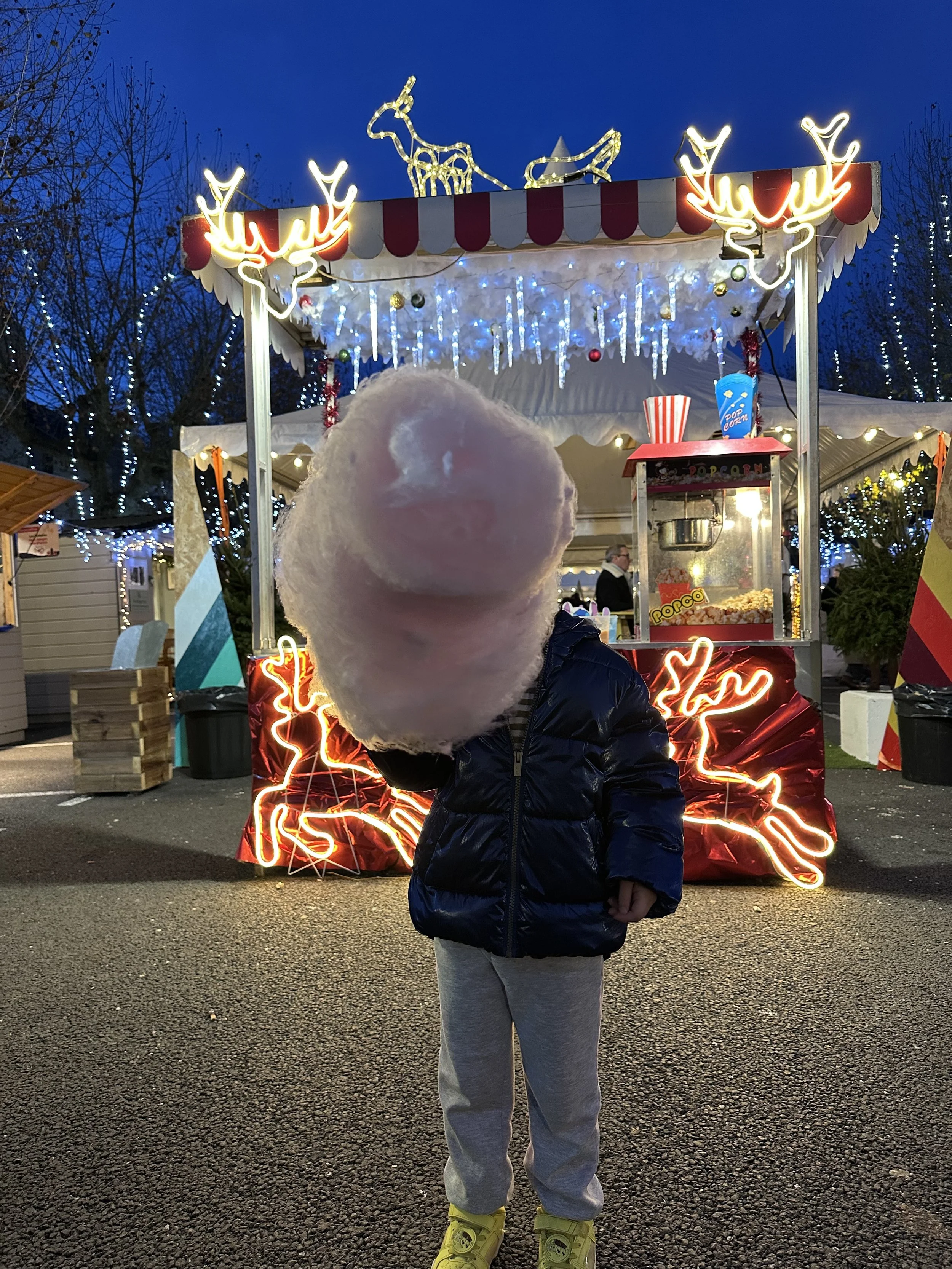 Cotton candy larger than the child in Bergerac Christmas market.