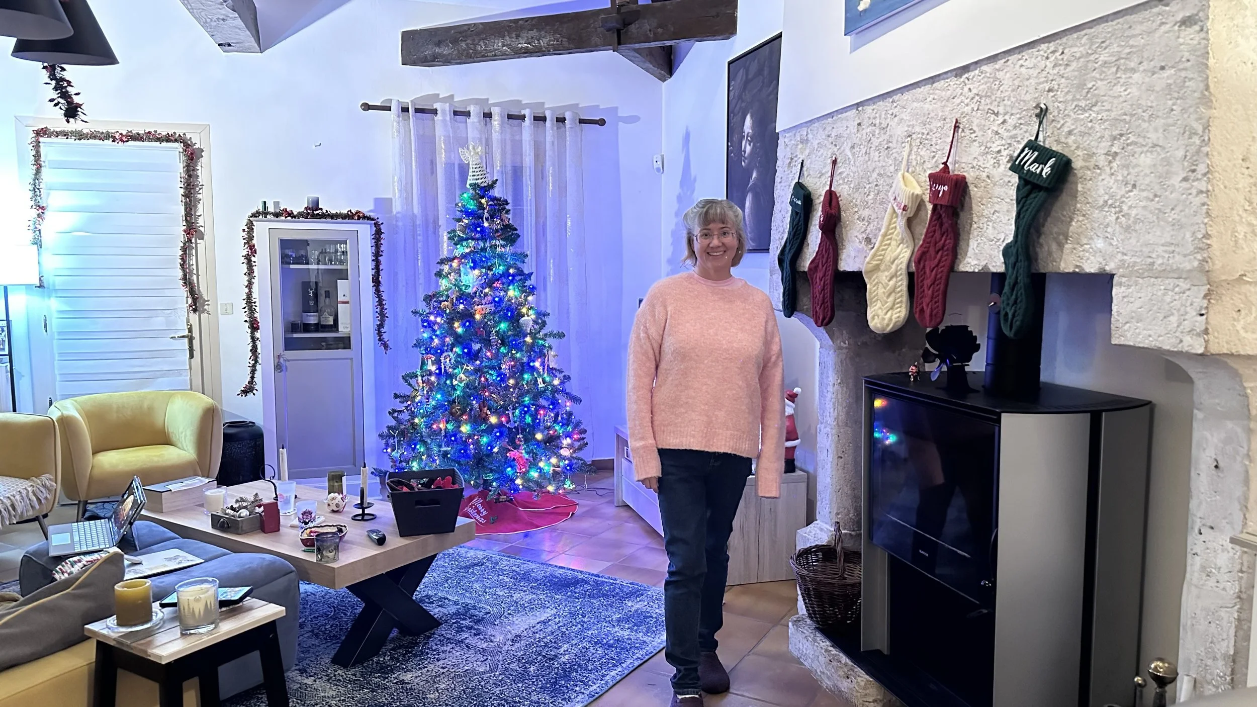 Christmas at La Tour Blanche with a Christmas tree, stockings hanging over the stone fireplace, and holiday decorations.
