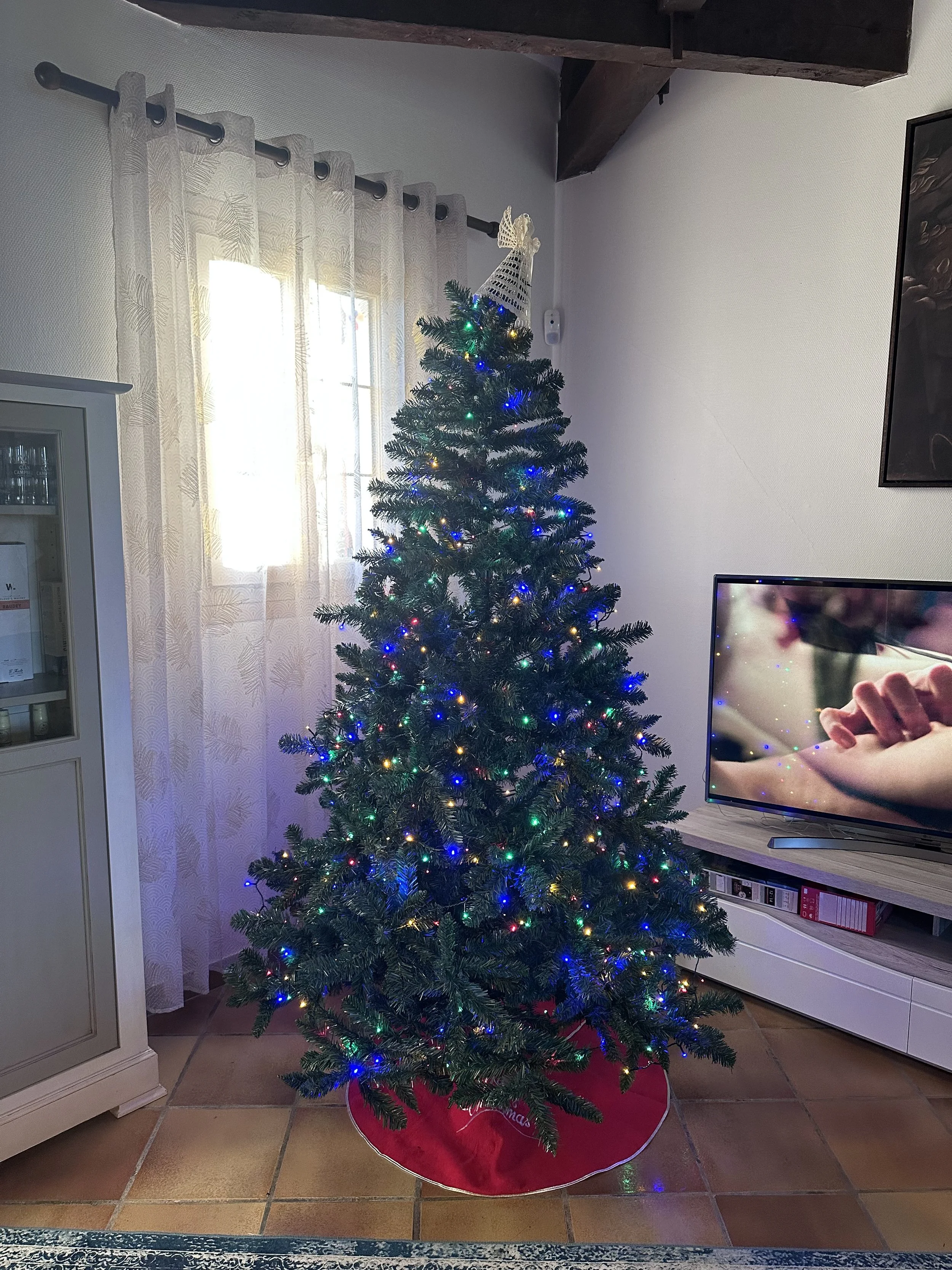 Christmas tree with colorful lights, ornaments, & garland at French House La Tour Blanche