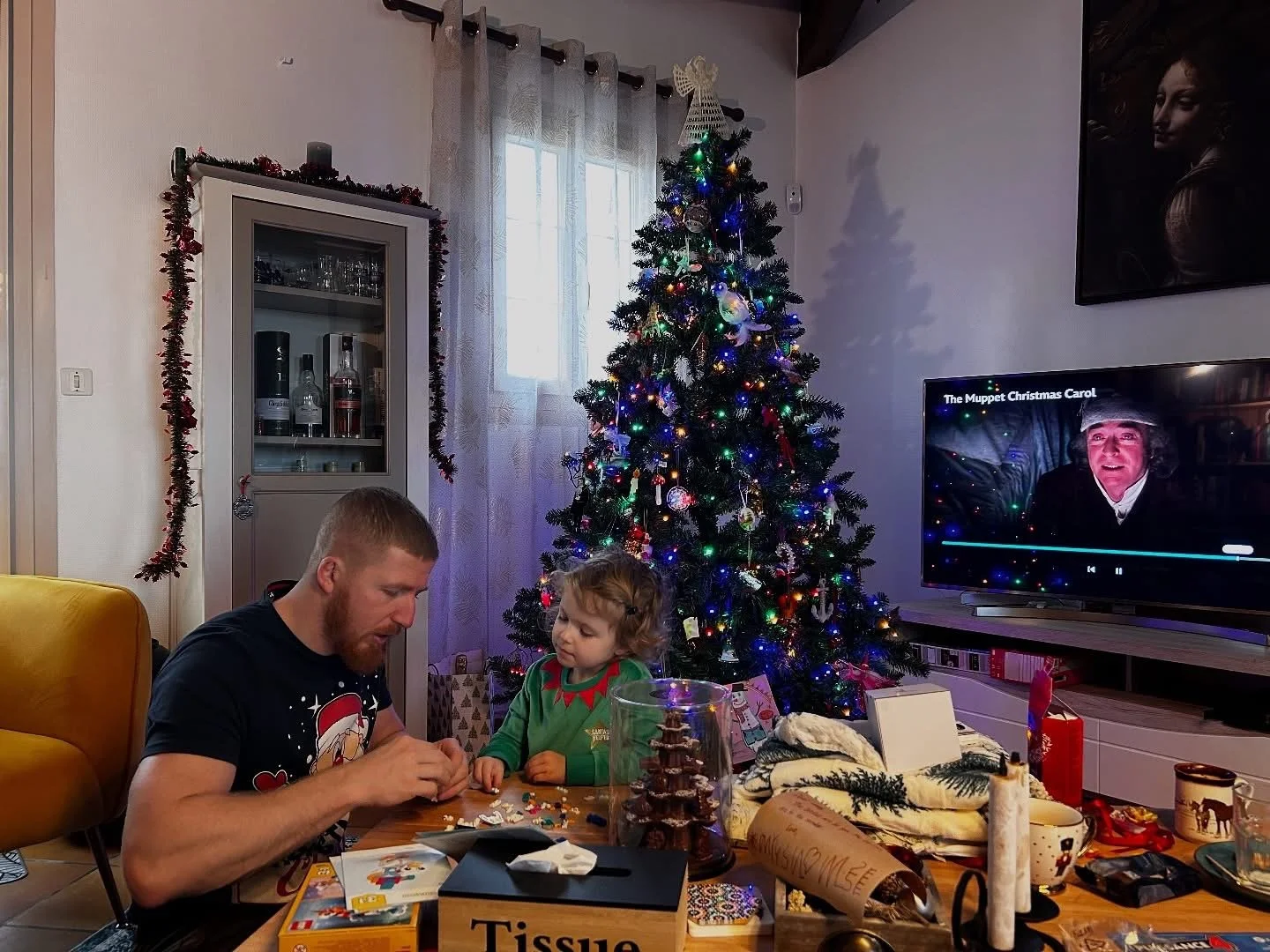 Man and a young girl opening Christmas presents at La Tour Blanche