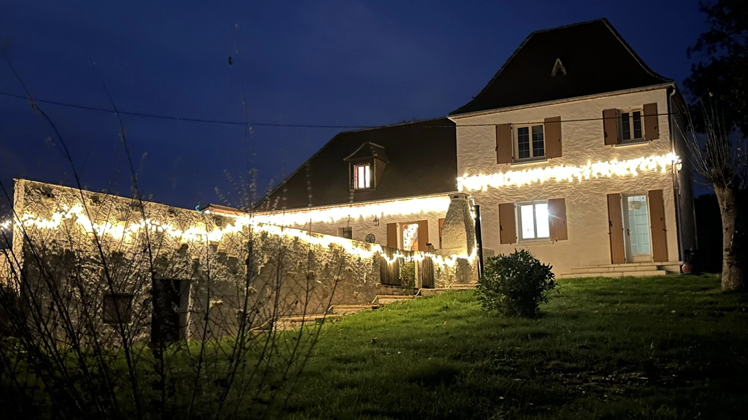 French House La Tour Blanche at night decorated with lights for Christmas.