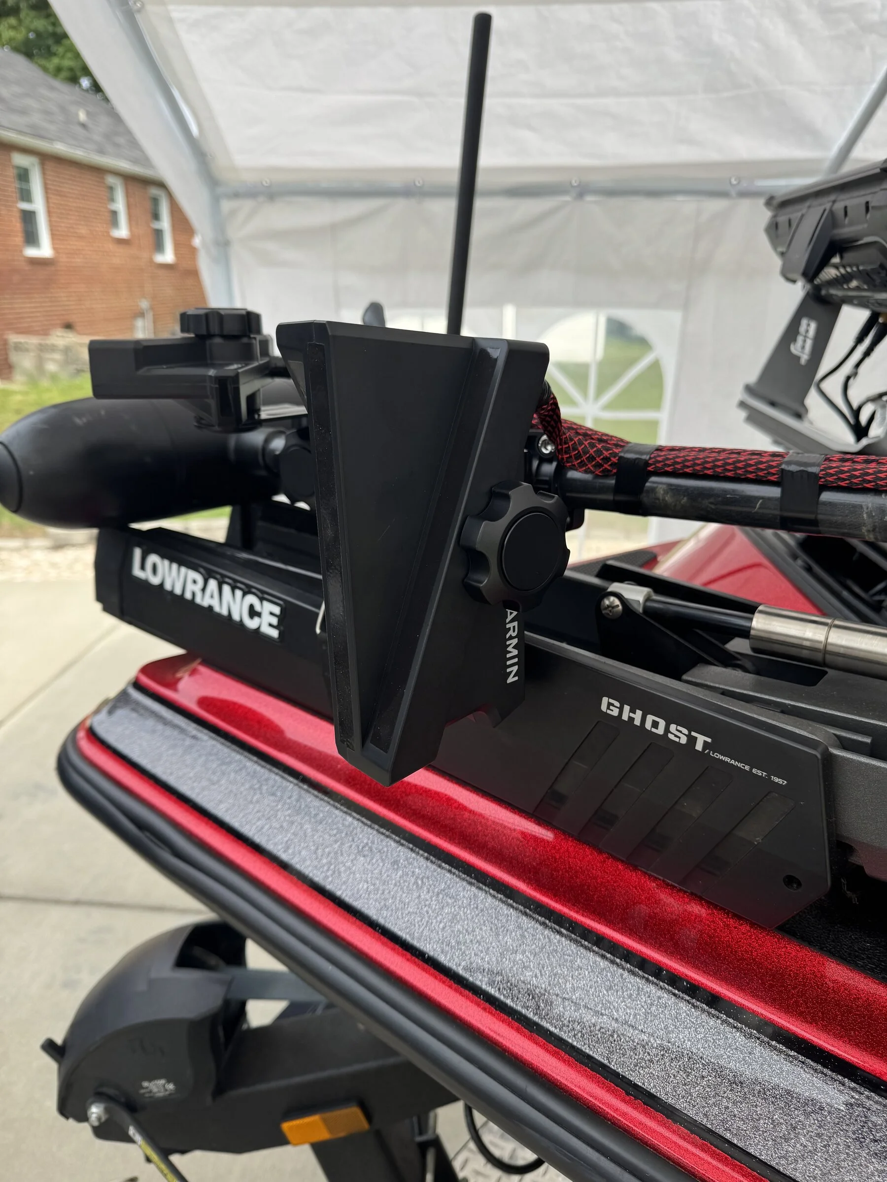 Close-up of the Garmin transducer mount and Lowrance Ghost trolling motor head on a Caymas CX20