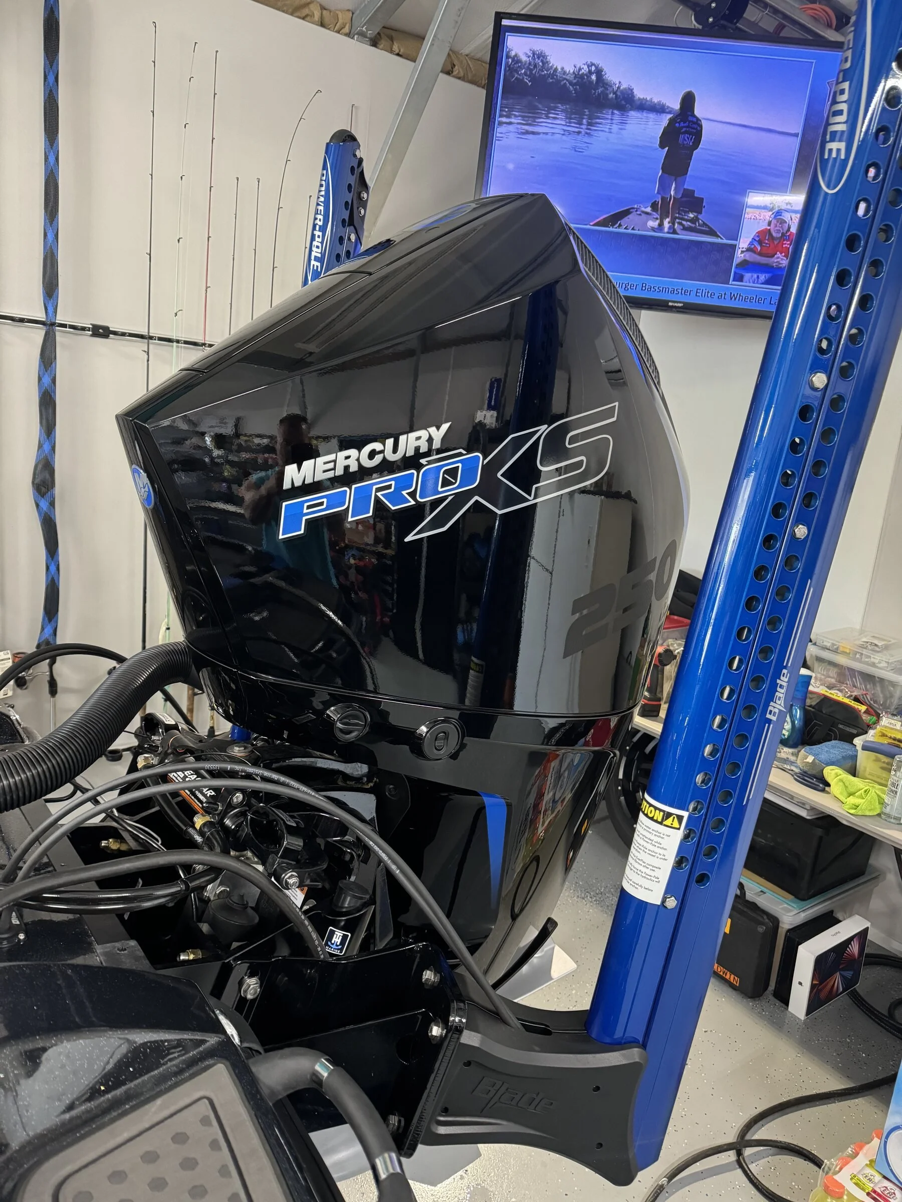 Mercury Pro XS 250 outboard installed and rigged, with our angler client competing at a Bassmaster Elite event in the background