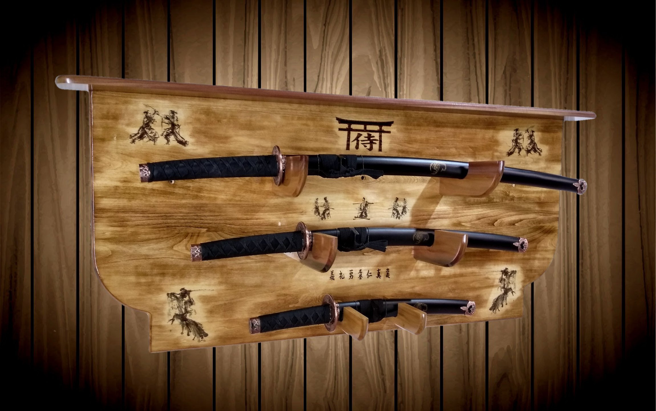 Three Japanese swords mounted on a wooden display wall with Asian calligraphy and artwork.