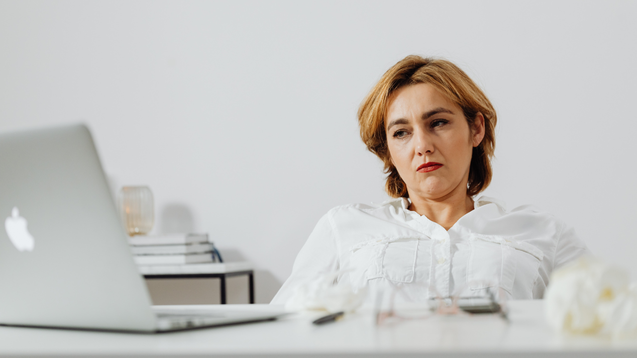 Estate planning attorney siting by her computer and evaluating a case she is working on.