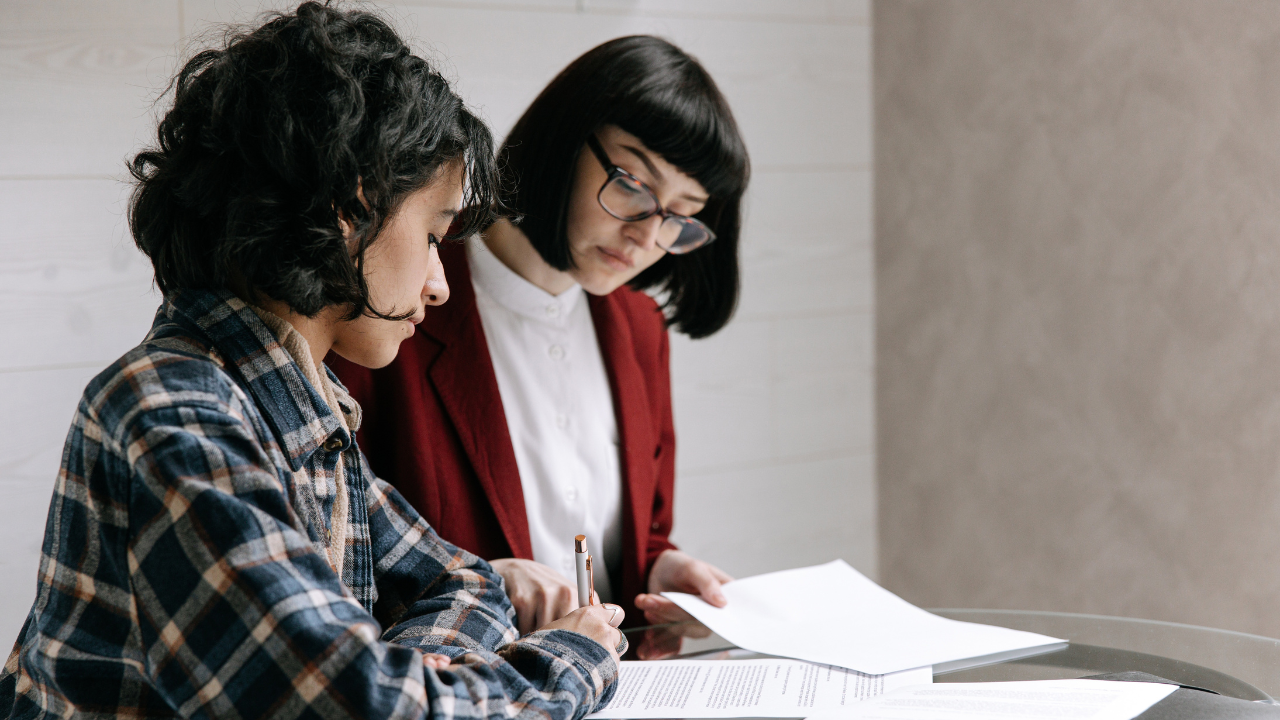 Estate planning lawyer helping her client understand documents she is signing.
