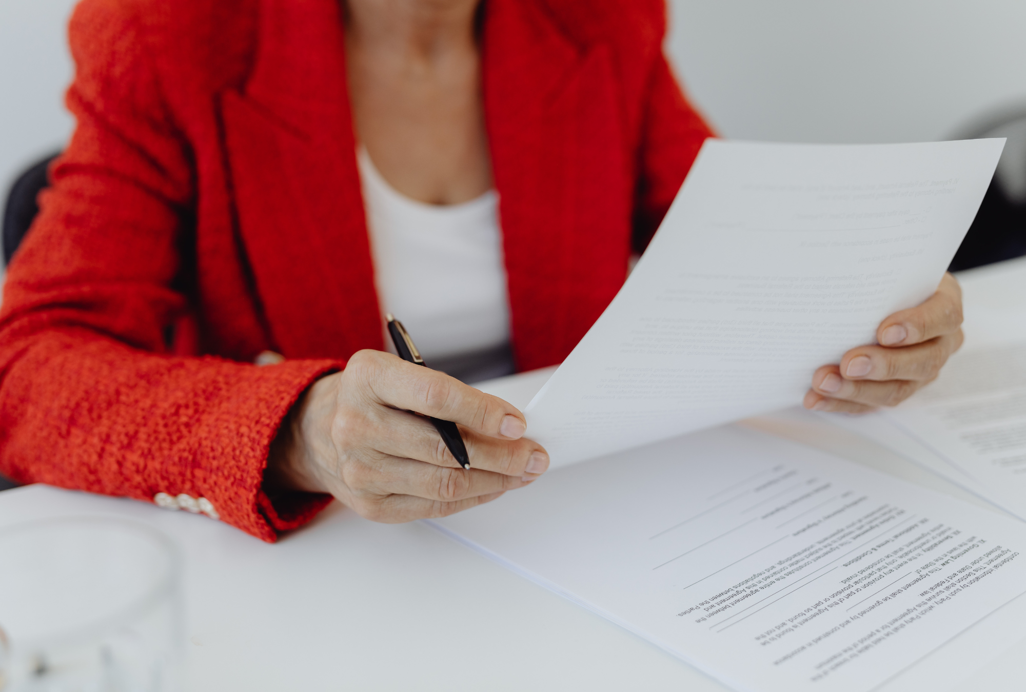 Woman reviewing business operating agreement and legal documents for recession proof small business planning