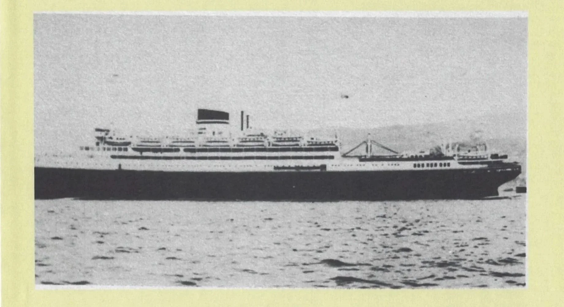 Vintage black and white photograph of a large paddle steamer ship at sea, with a flag flying from the ship's smokestack, and distant land visible in the background.