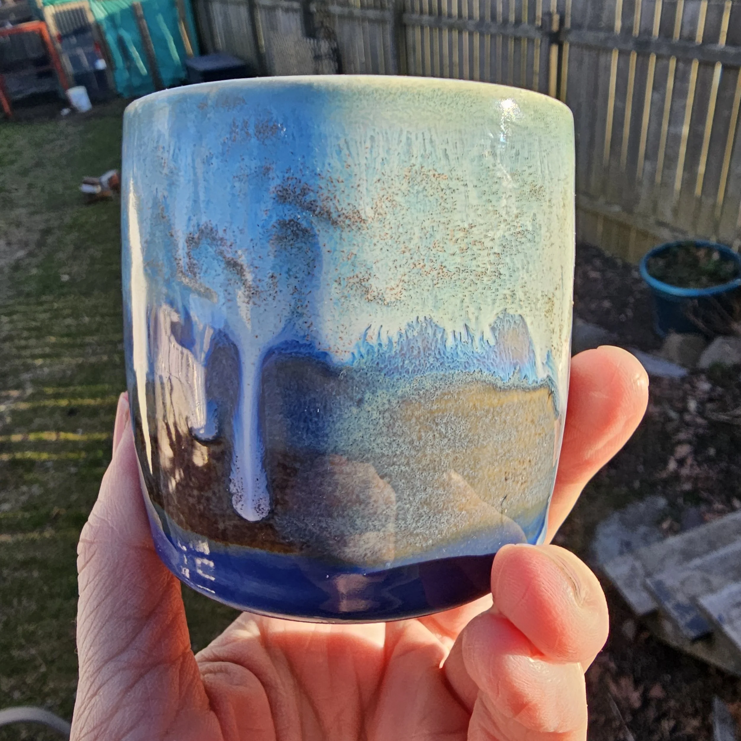 Cup with white, blue green and brown glaze.