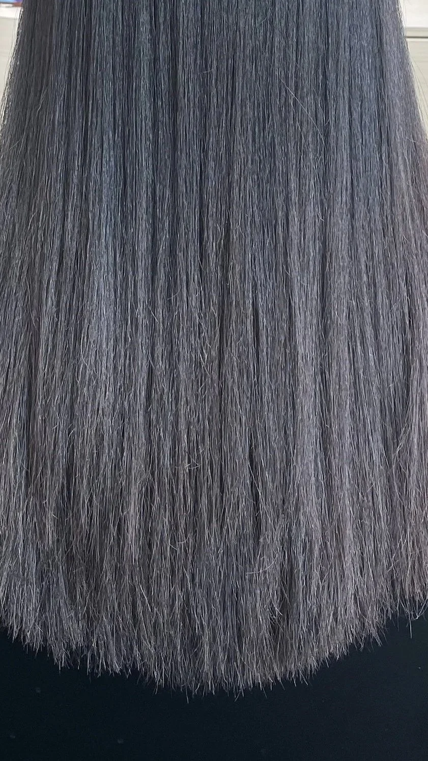 Close-up of shiny, straight, silk pressed hair.