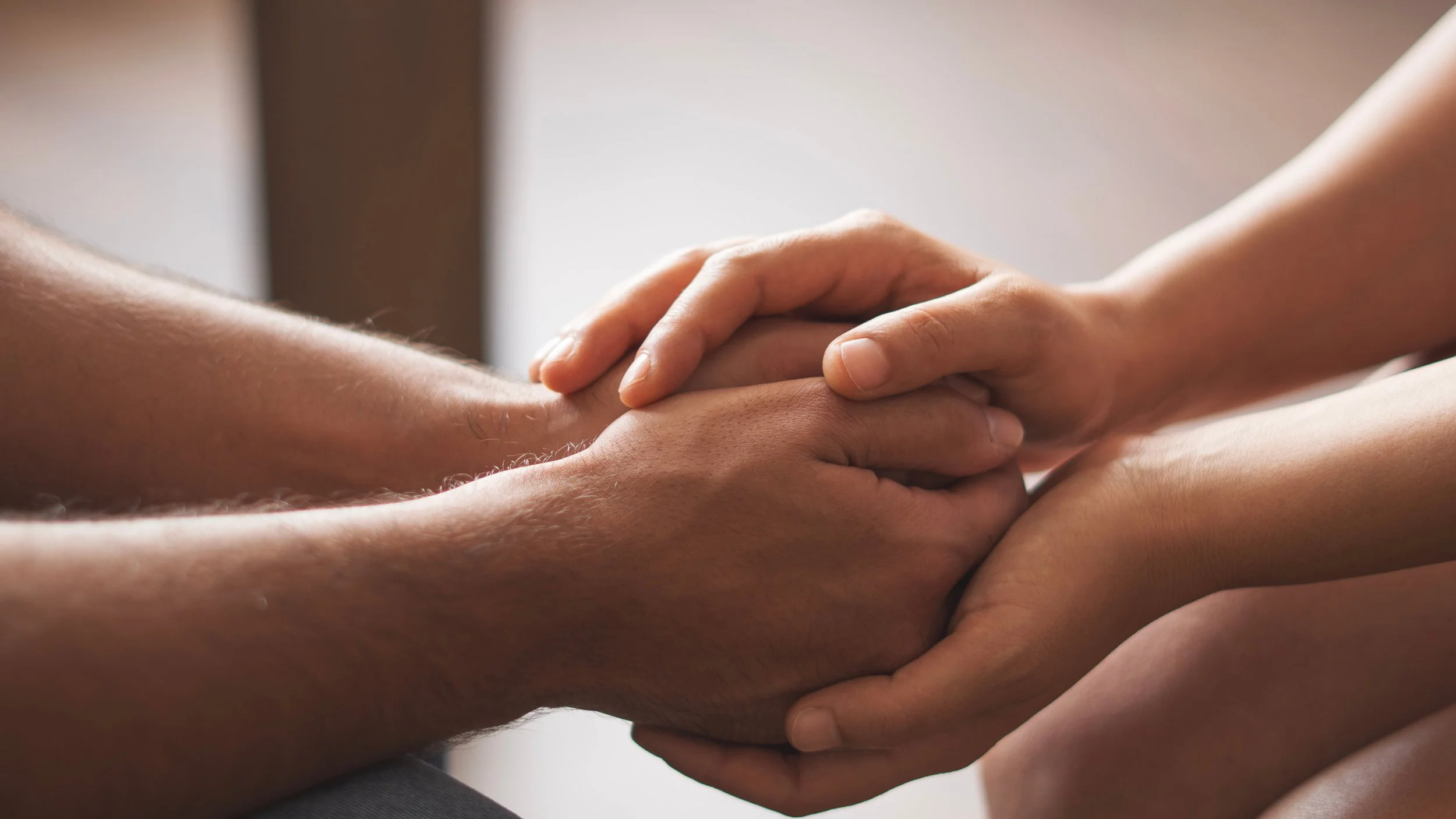 Hands in couples therapy, showing closeness, intimacy, trust, connection after conflict
