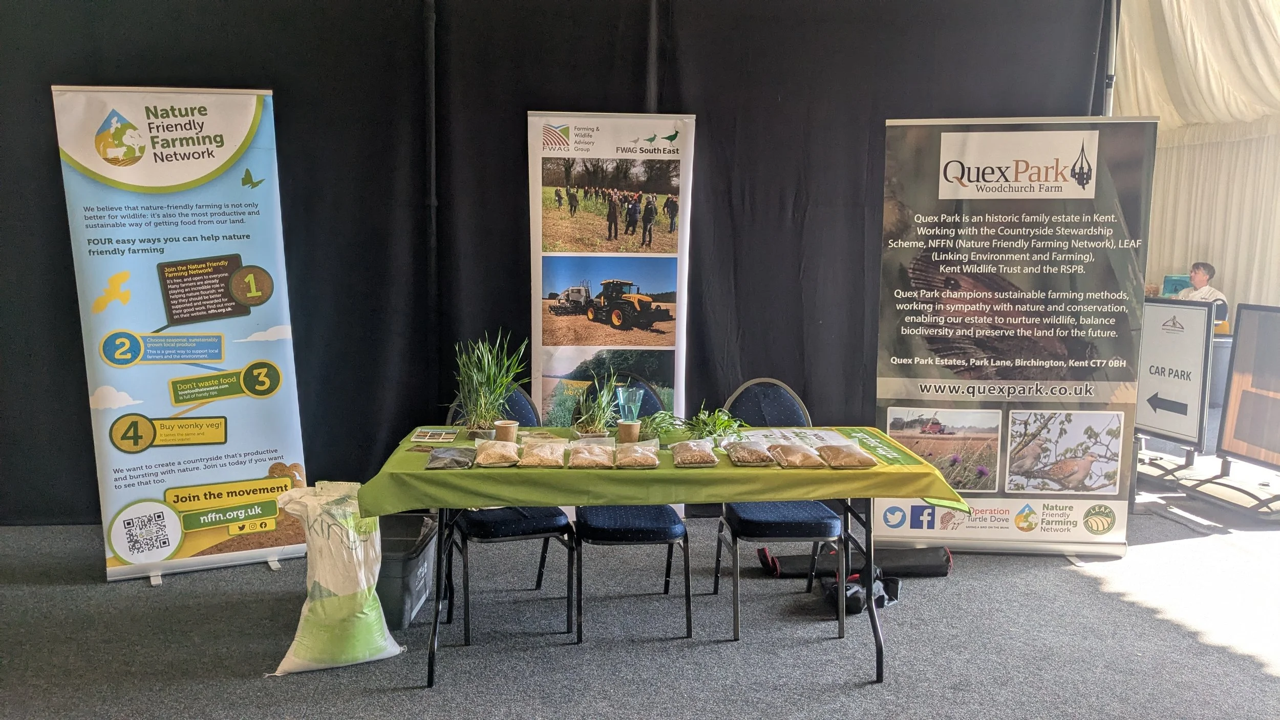 Exhibit table at an event promoting nature-friendly farming.