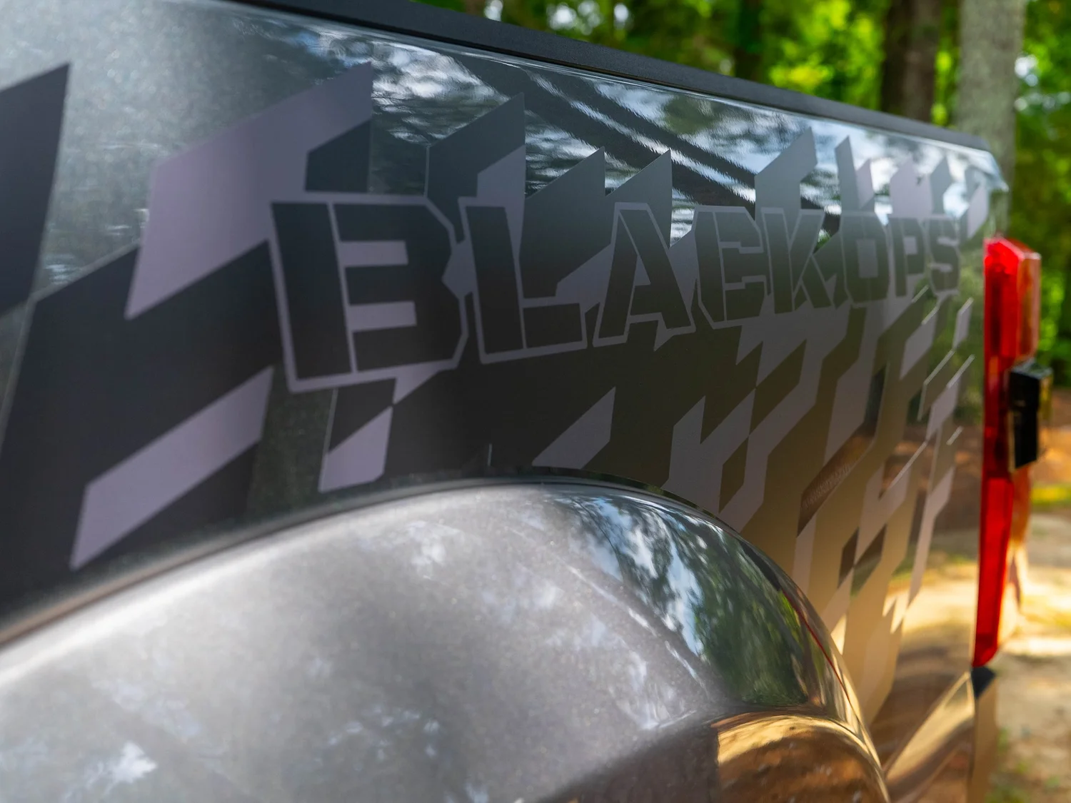 Black Ops side graphic lettering near the taillight of an F-250 Super Duty Black Ops