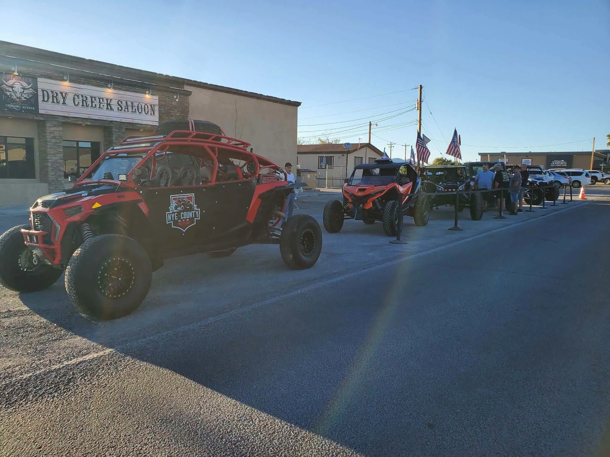 Nye County SxS branded UTVs lined up outside Dry Creek Saloon for the September 2026 monthly meet