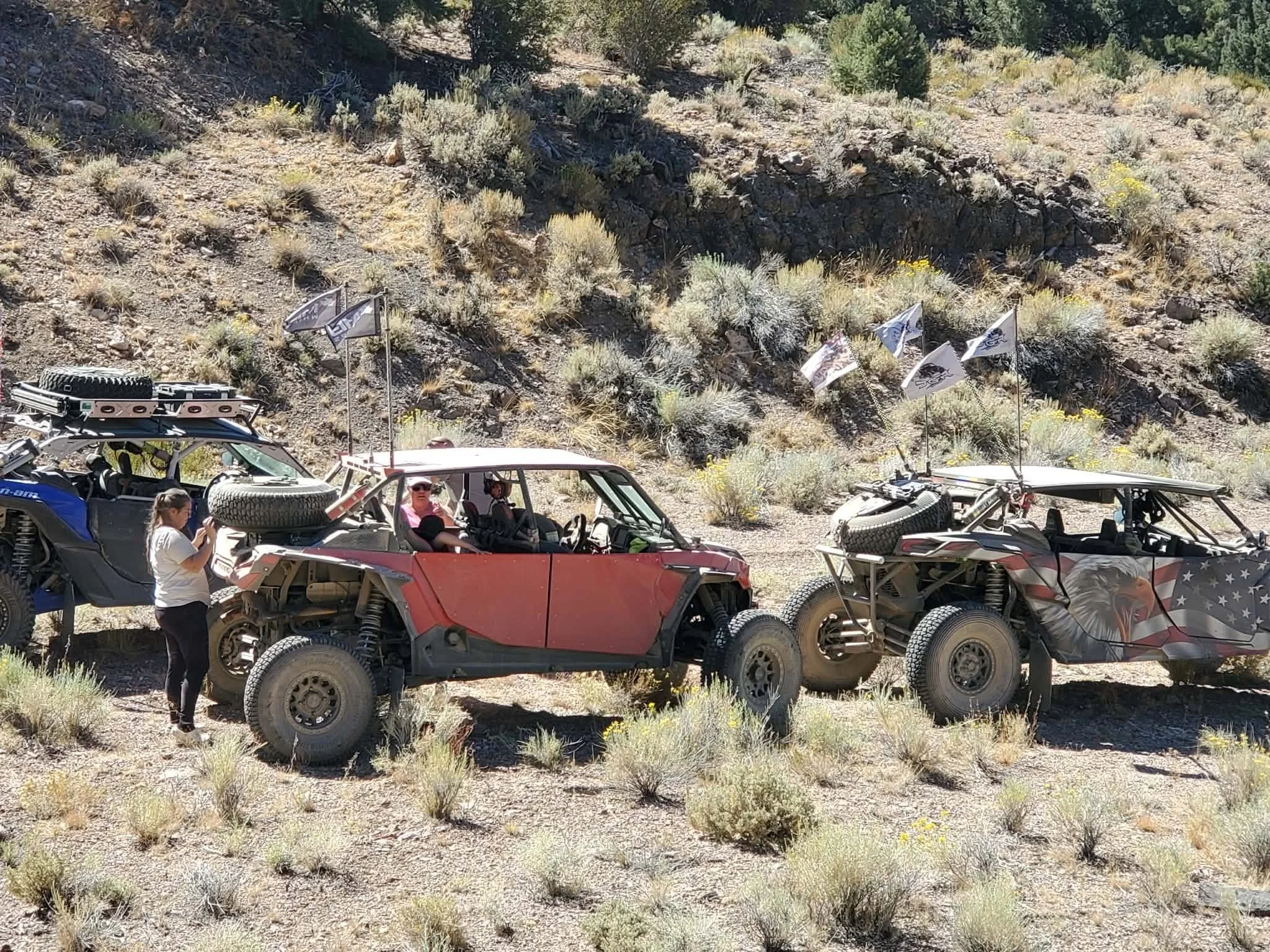 Line of off-road UTVs parked on a hillside trail during the 2026 Dyer - Fish Lake Poker Run