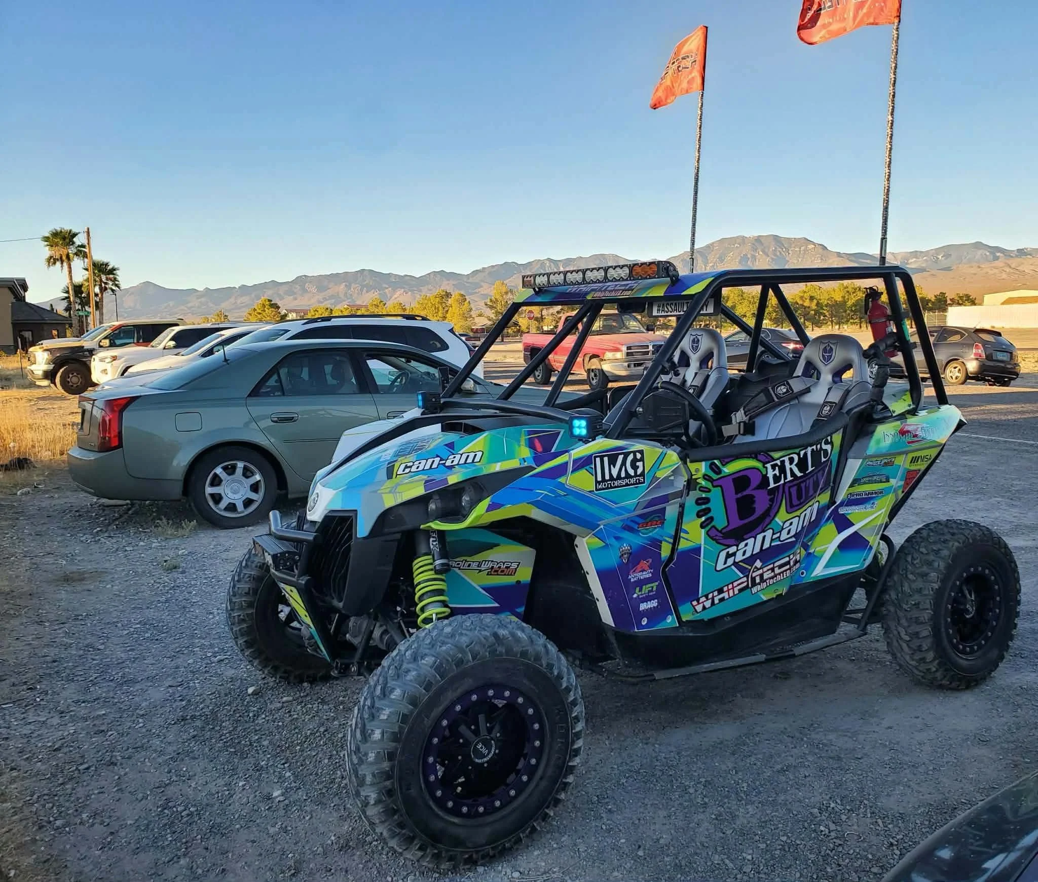 Bert's UTV custom-wrapped Can-Am off-road vehicle with full roll cage at the September 2026 Nye County SxS monthly meet