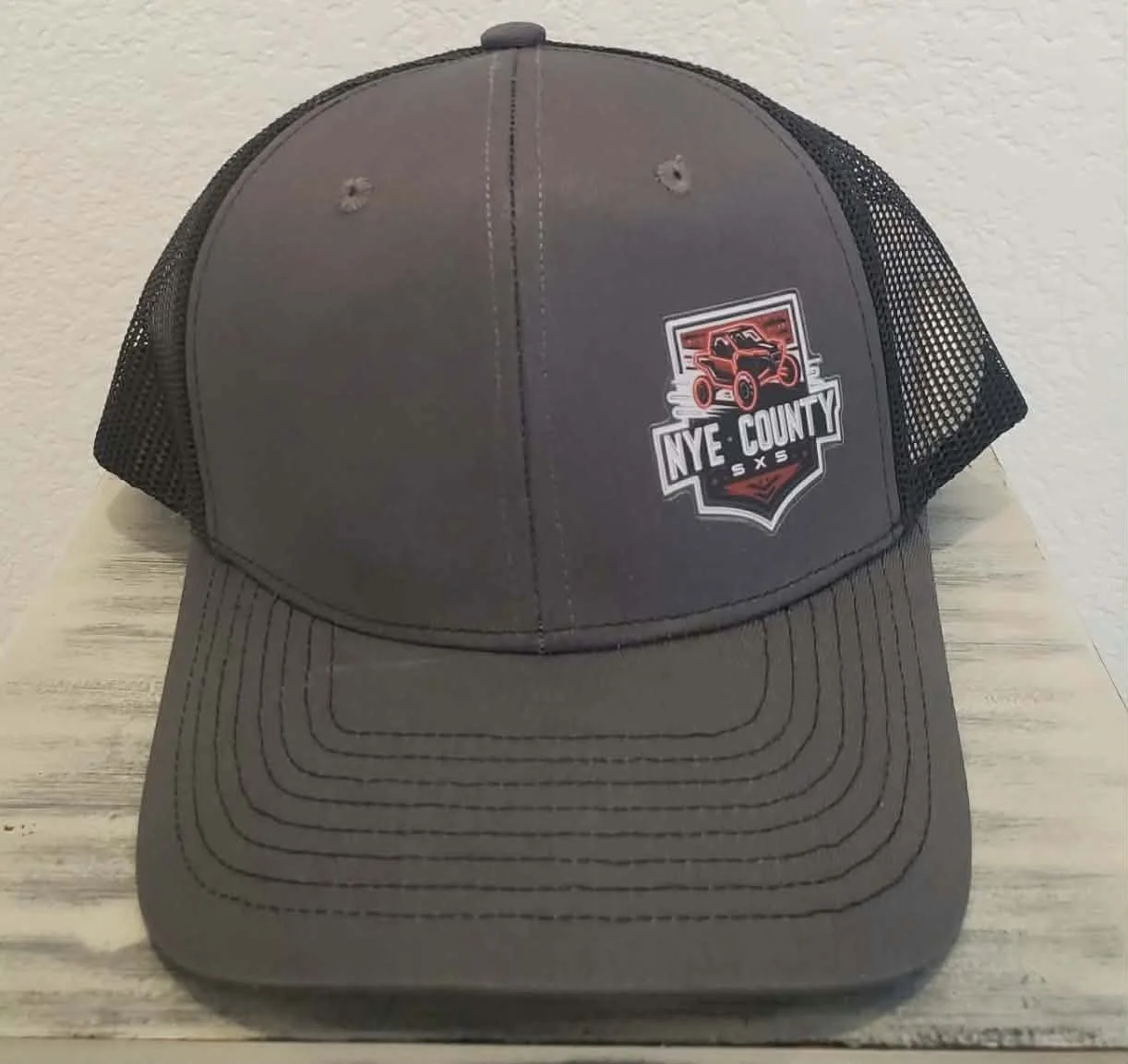 Gray Nye County SXS trucker hat front view with embroidered off-road club patch