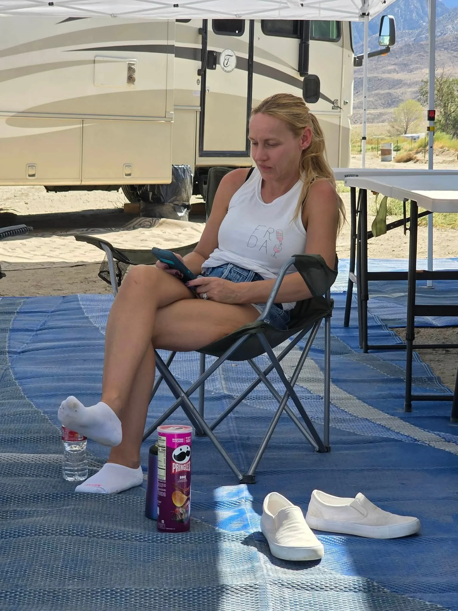 Rider relaxing in a camp chair at the campsite during the 2026 Dyer - Fish Lake Poker Run