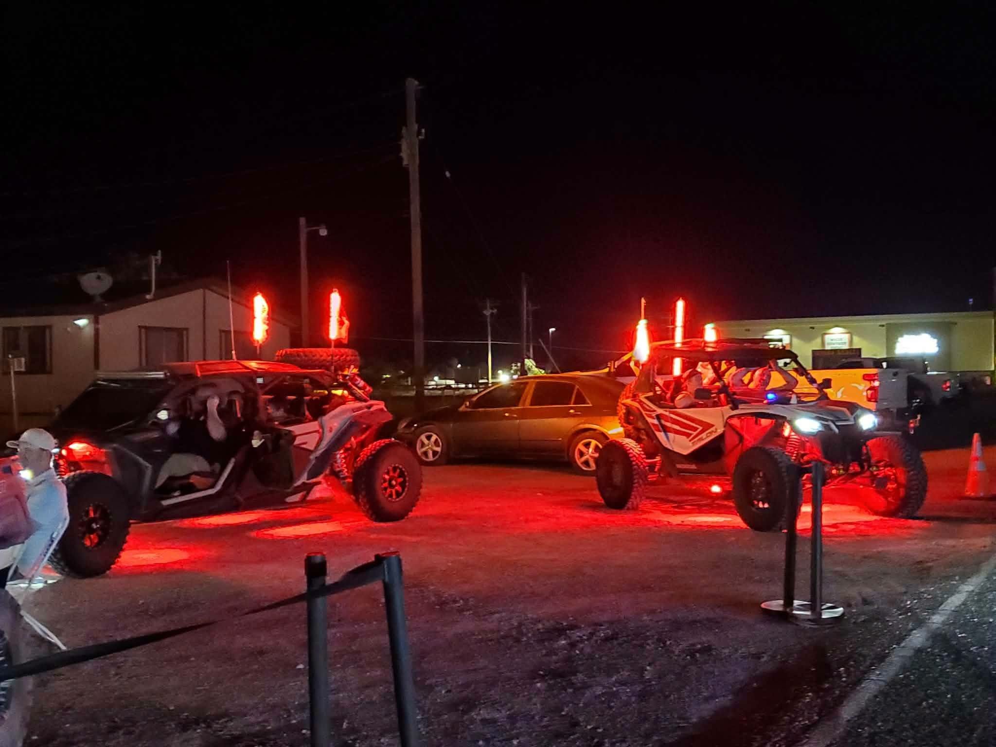 Off-road UTVs with red underglow lighting parked at night during the September 2026 Nye County SxS monthly meet